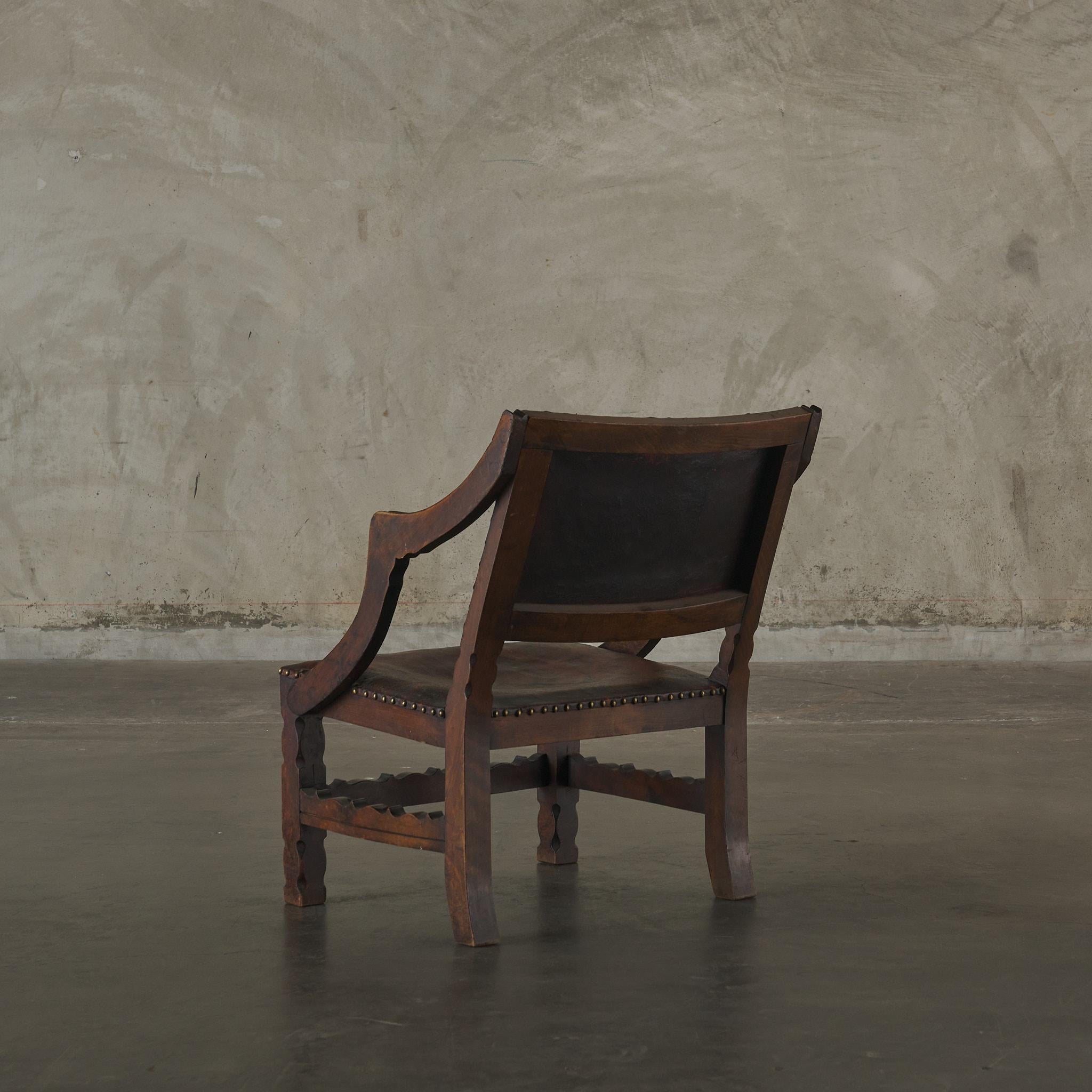 Carved Spanish Colonial Leather Studded Low Arm Chair For Sale