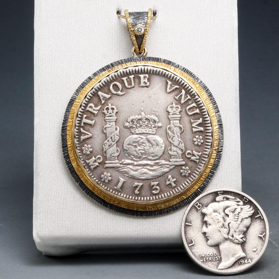 An authentic silver 2 Reales coin minted in the Spanish colony of Mexico in 1734 depicts the 
