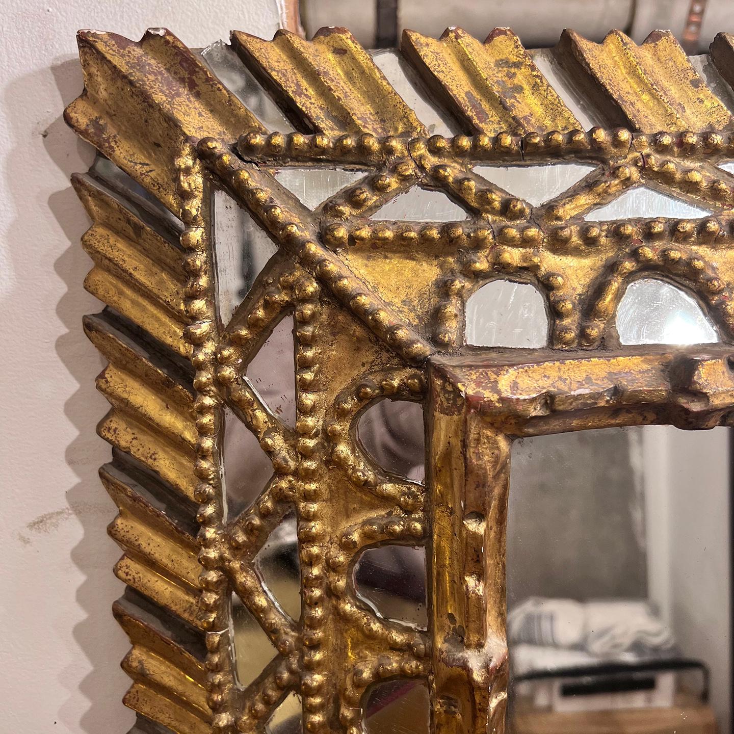 Late 19th Century Spanish colonial gilt wood mirror with mirror insets.

Measurements:
Height: 55.5