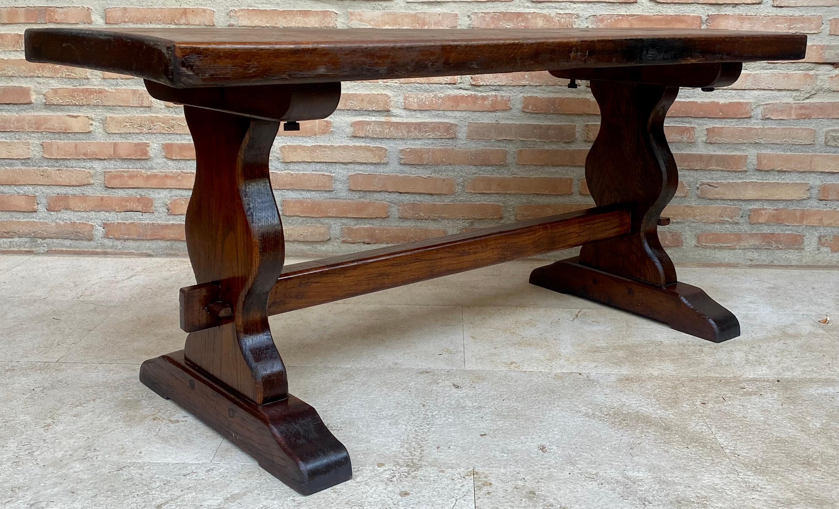 
Spanish colonial narrow console table.
This piece has legs with two pedestals joined by a wooden stretcher.