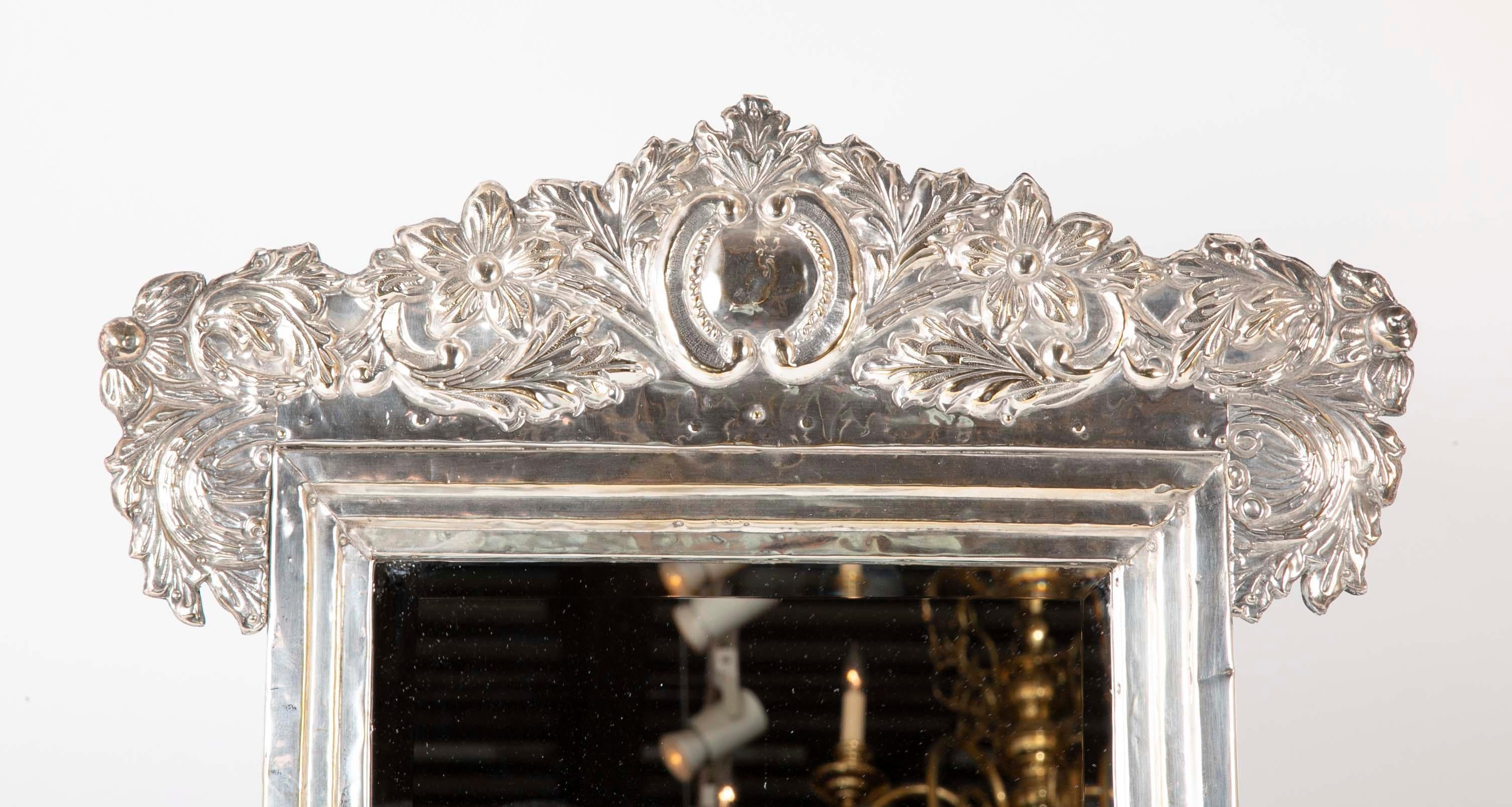 A Spanish Colonial style silver picture frame with mirror. The handsome rectangular frame with Baroque style crest would be great for a small painting or that special photograph. Or as it is now, a beautiful vanity mirror. No hallmarks but tests as