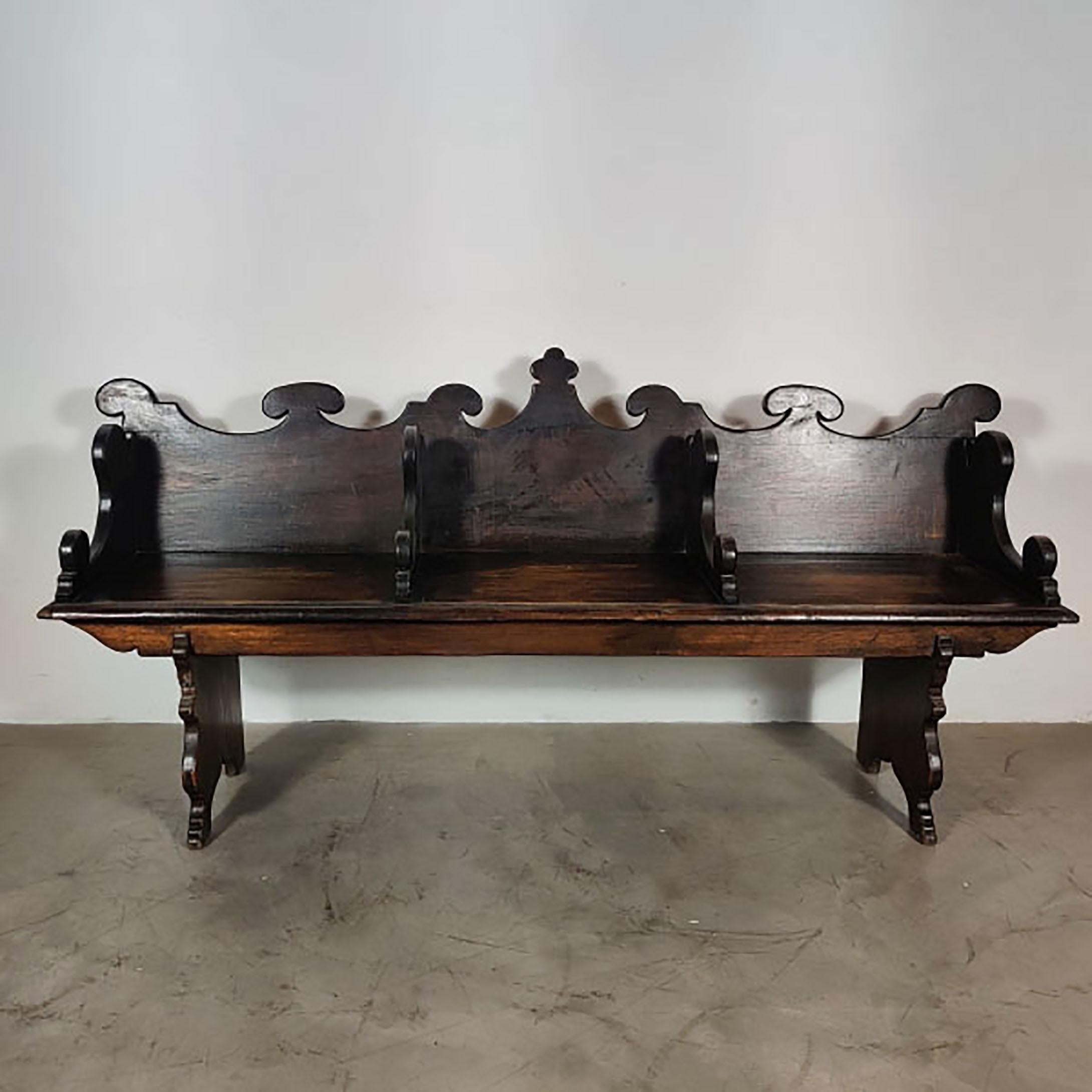 This remarkable bench, crafted in the Spanish Colonial Revival style around the 1930s, is a testament to the revival of classical Spanish design with an artisanal touch. The piece exudes a timeless elegance, featuring three distinct seating