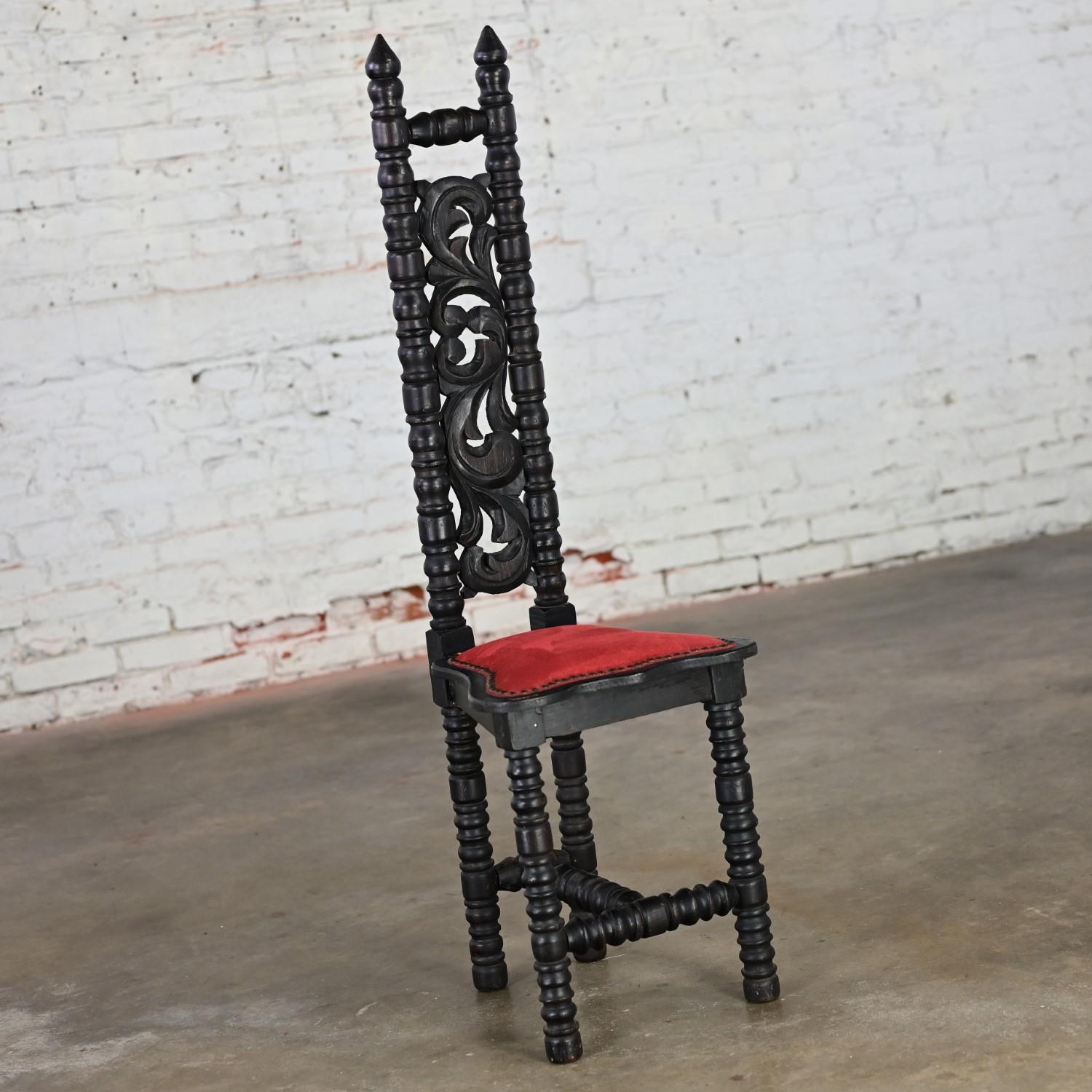 Outstanding vintage Spanish Colonial Revival or Mediterranean style small narrow high back chair comprised of dark stained wood with red velvet upholstery trimmed with steel nail head details in the style of WITCO. Beautiful condition, keeping in