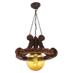Spanish Colonial Ring Pendant Light Fixture in Carved Wood & Amber Glass, 1950