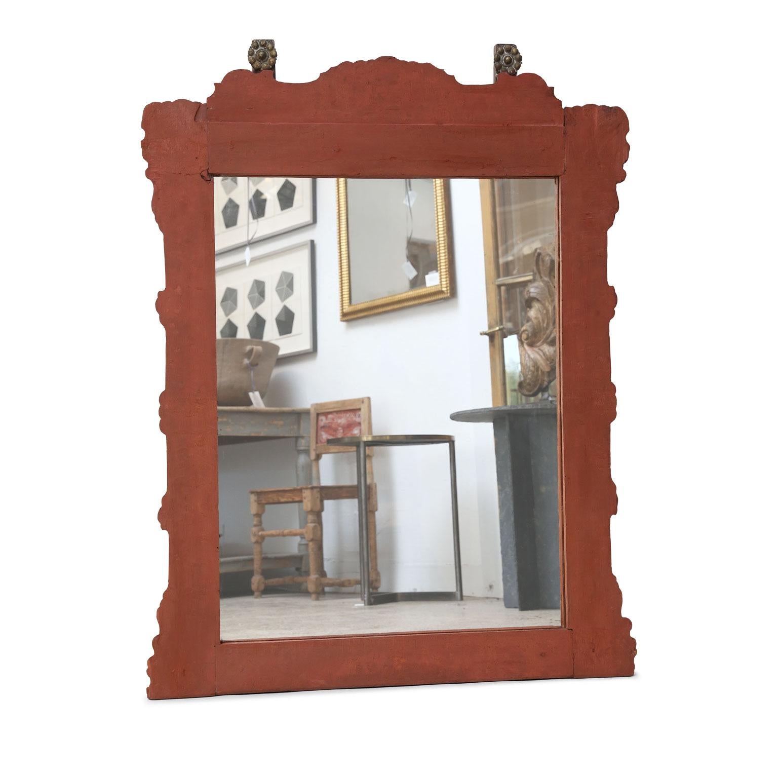 Spanish Colonial style mirror, circa 1840-1860. Mid-19th century unusually large Mexican mirror bearing refreshed early paint and decorative gilt tole medallions. Later mirror.