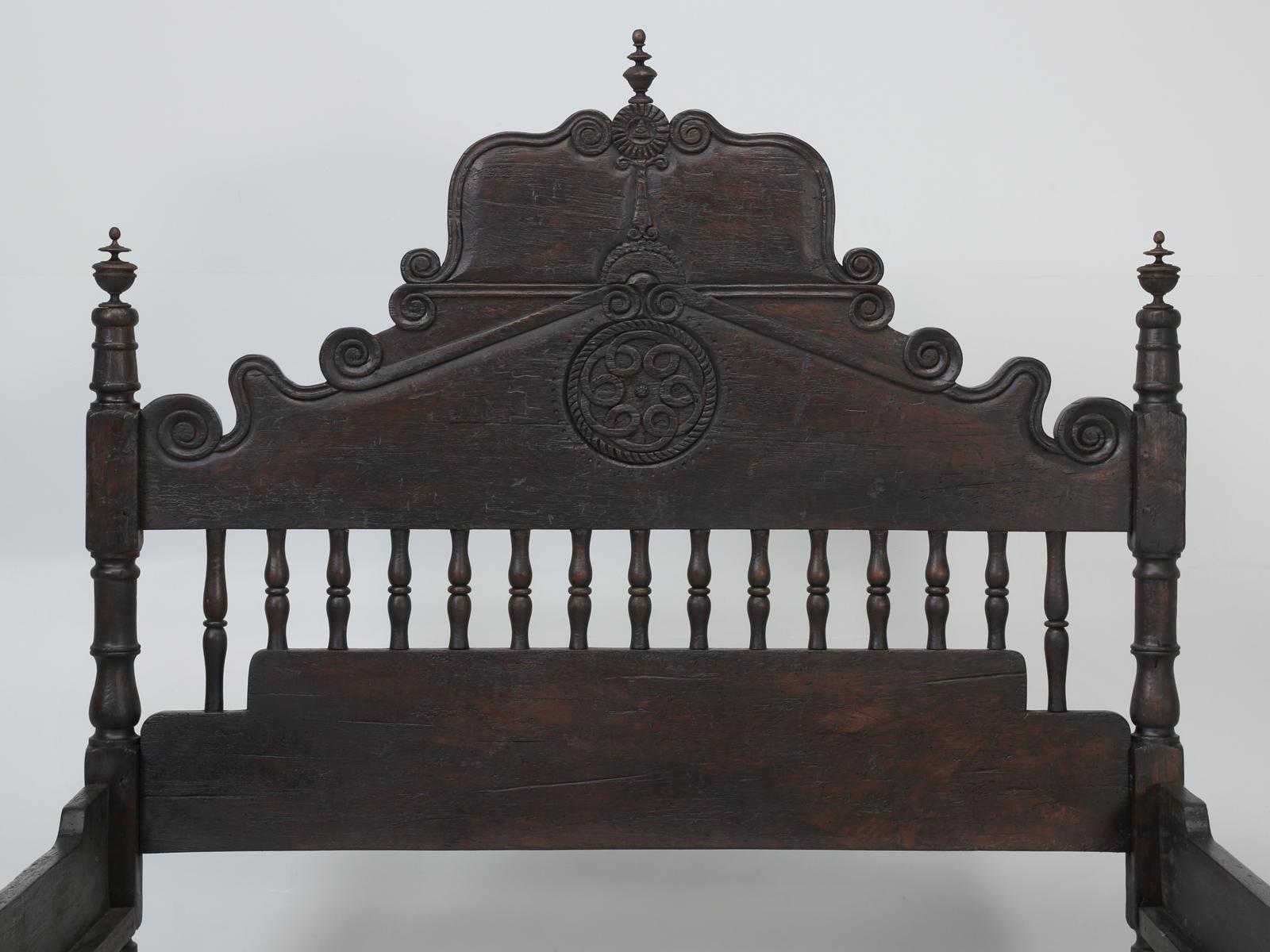 Proper reproduction of an antique Spanish Colonial Queen bed, made from solid mahogany, in an American Queen size. The Spanish Colonial style Queen style bed was hand carved in Peru by local artisans, while all the distressing and finishing details