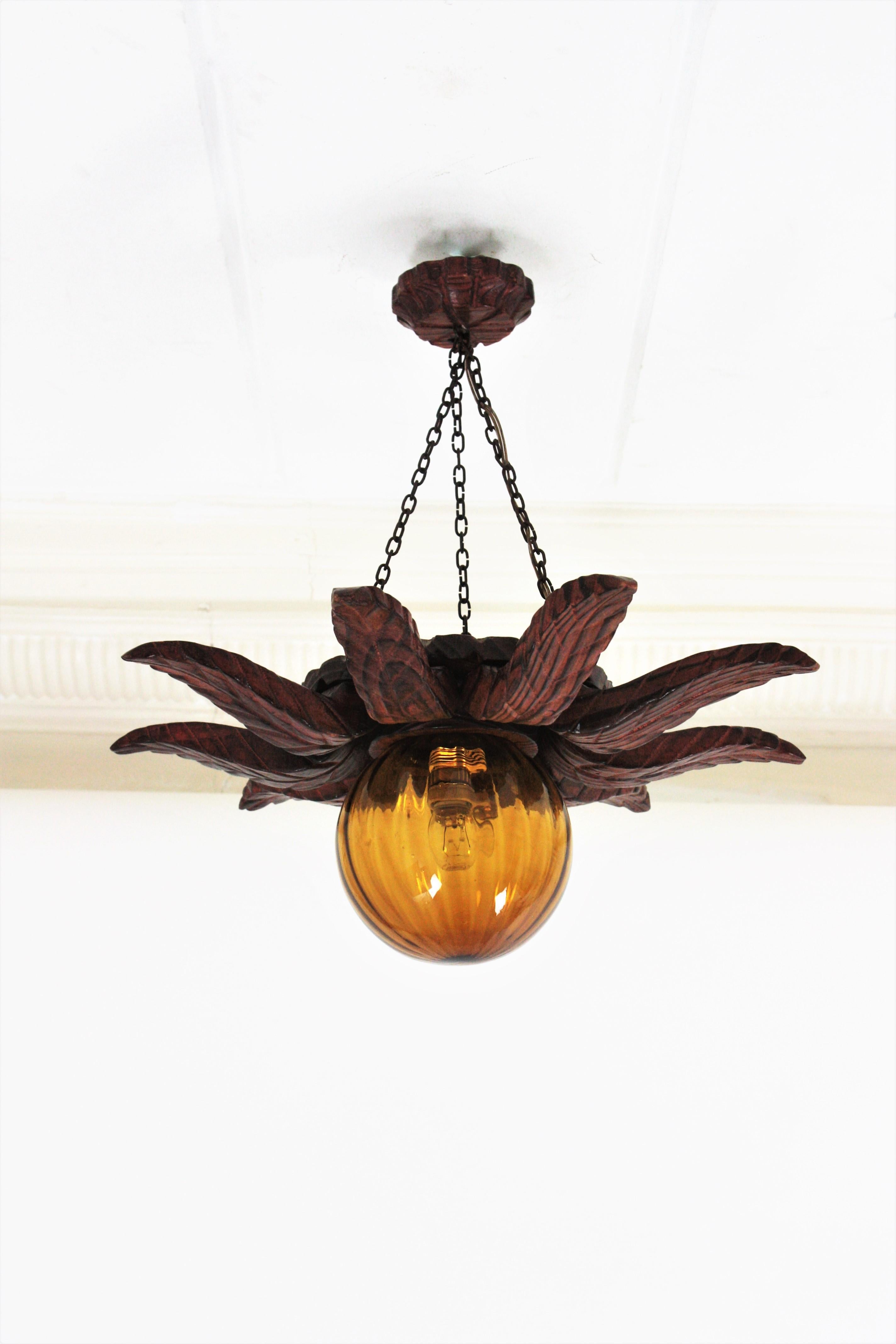 Spanish Colonial Sunburst Light Fixture in Carved Wood with Amber Glass Globe For Sale 6