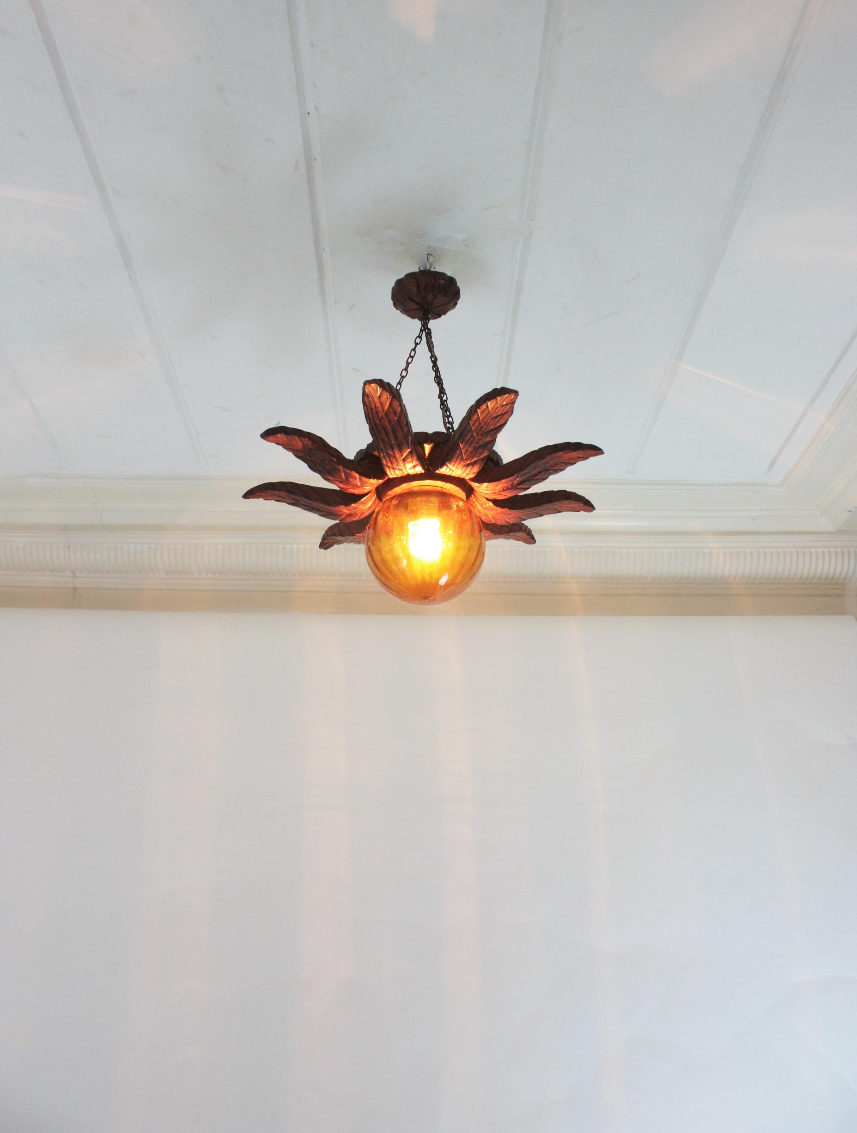 Spanish Colonial Sunburst Light Fixture in Carved Wood with Amber Glass Globe For Sale 9