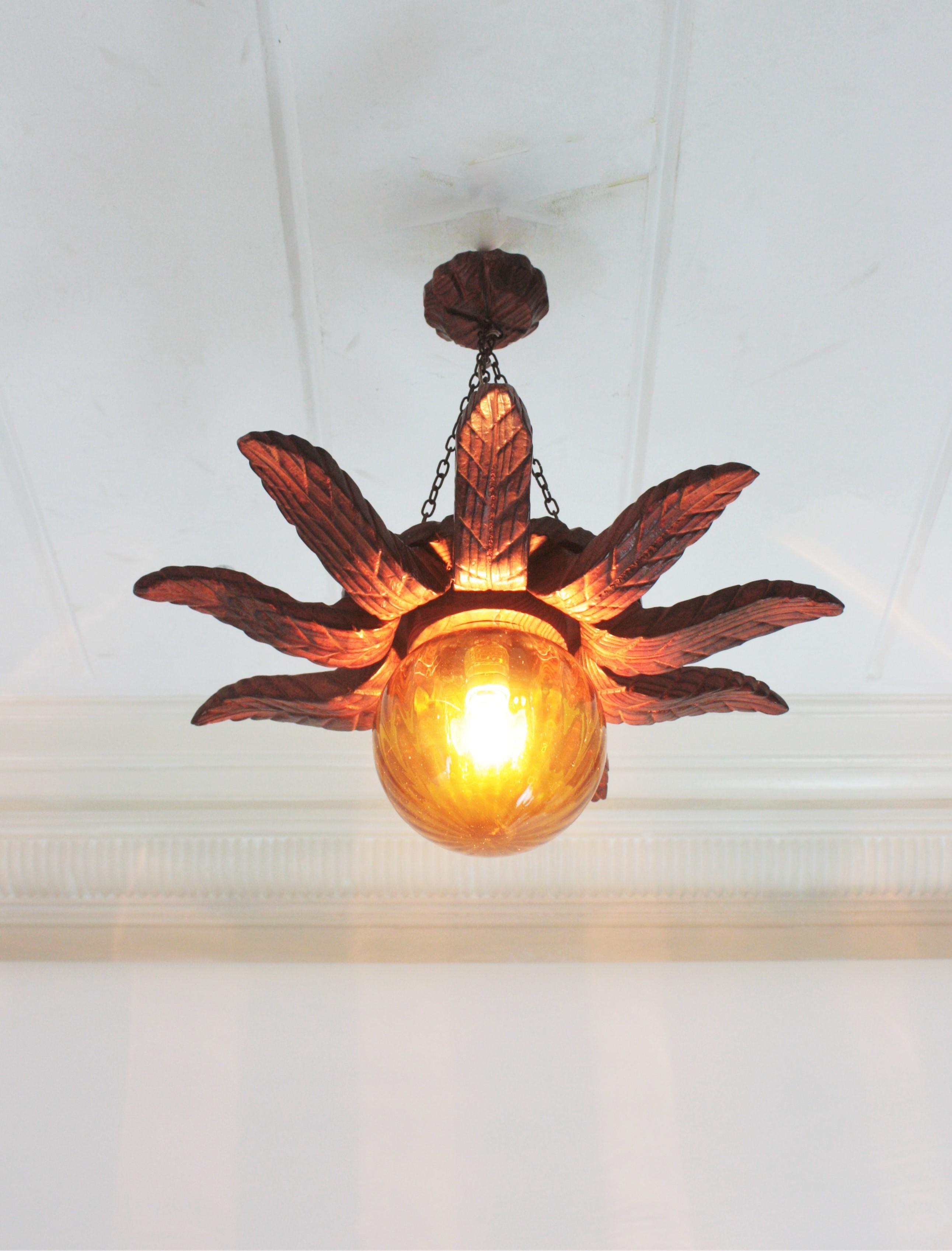 Spanish Colonial Sunburst Light Fixture in Carved Wood with Amber Glass Globe For Sale 10