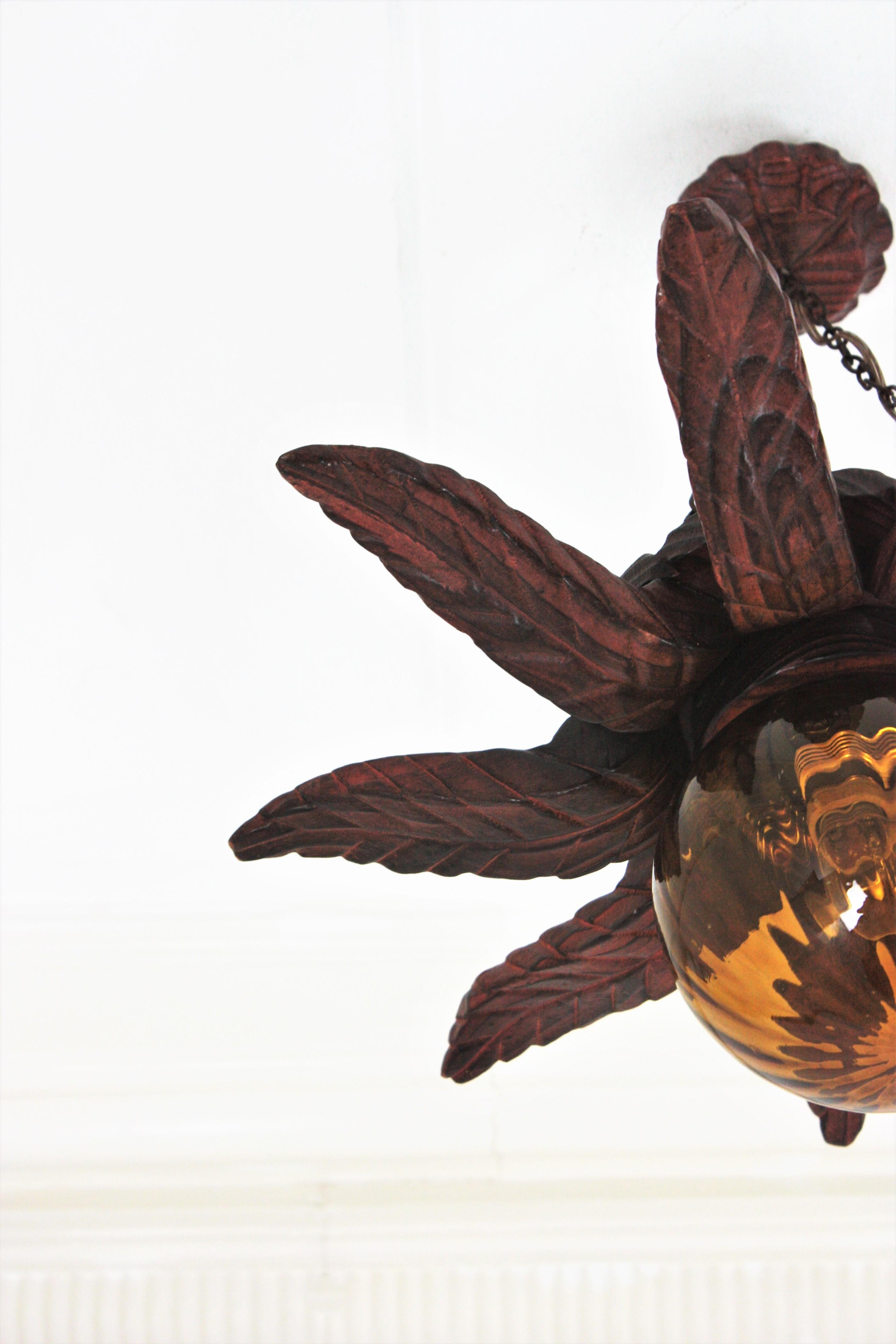 Spanish Colonial Sunburst Light Fixture in Carved Wood with Amber Glass Globe For Sale 11