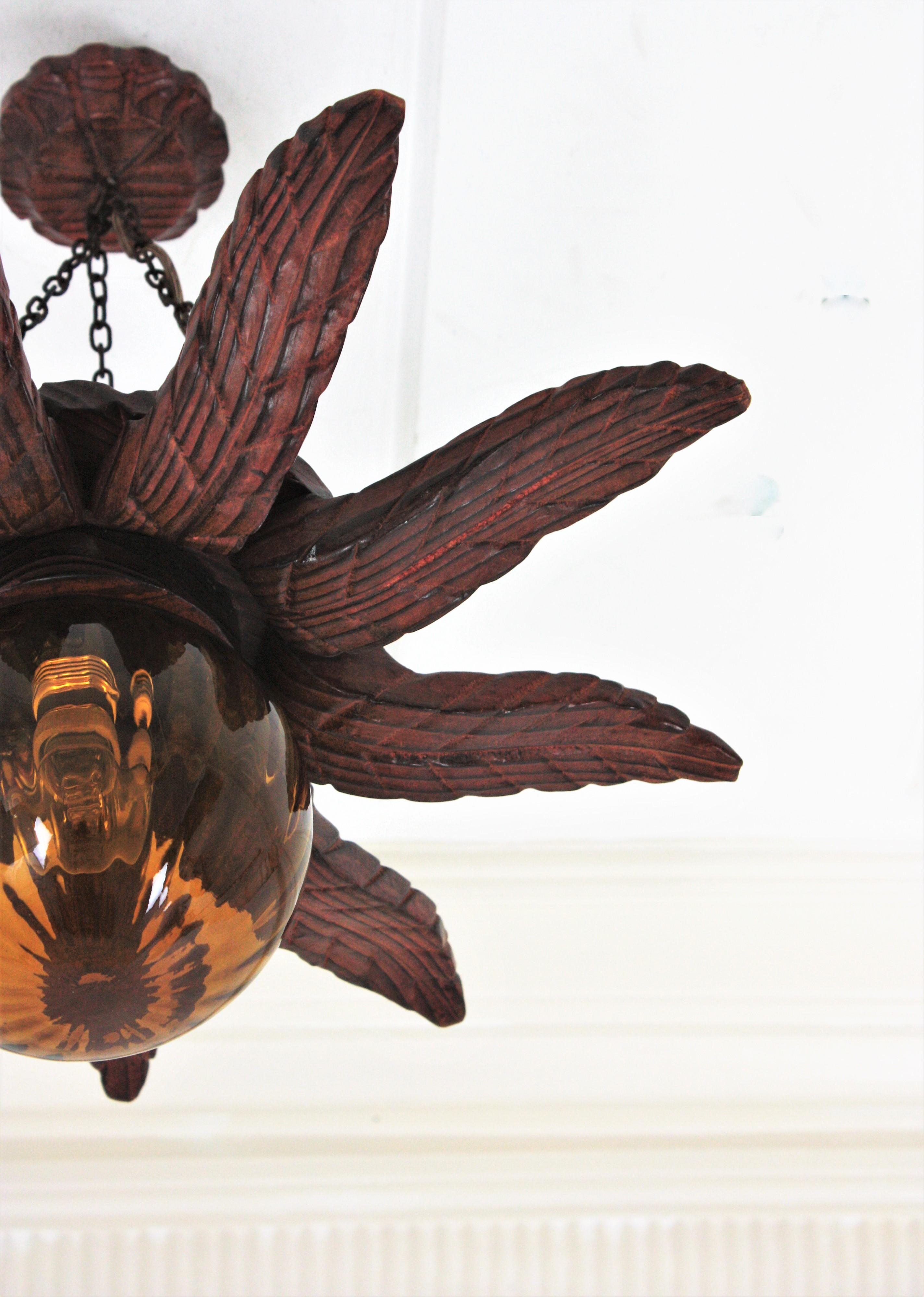 Spanish Colonial Sunburst Light Fixture in Carved Wood with Amber Glass Globe For Sale 12