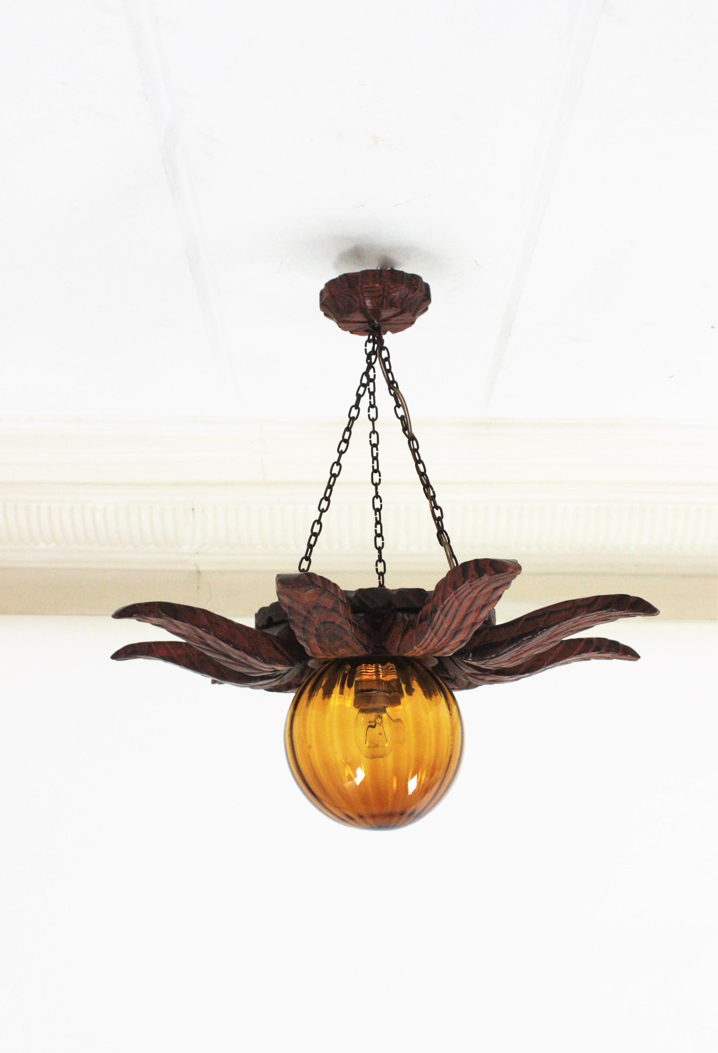 Spanish Colonial Sunburst Light Fixture in Carved Wood with Amber Glass Globe For Sale 2