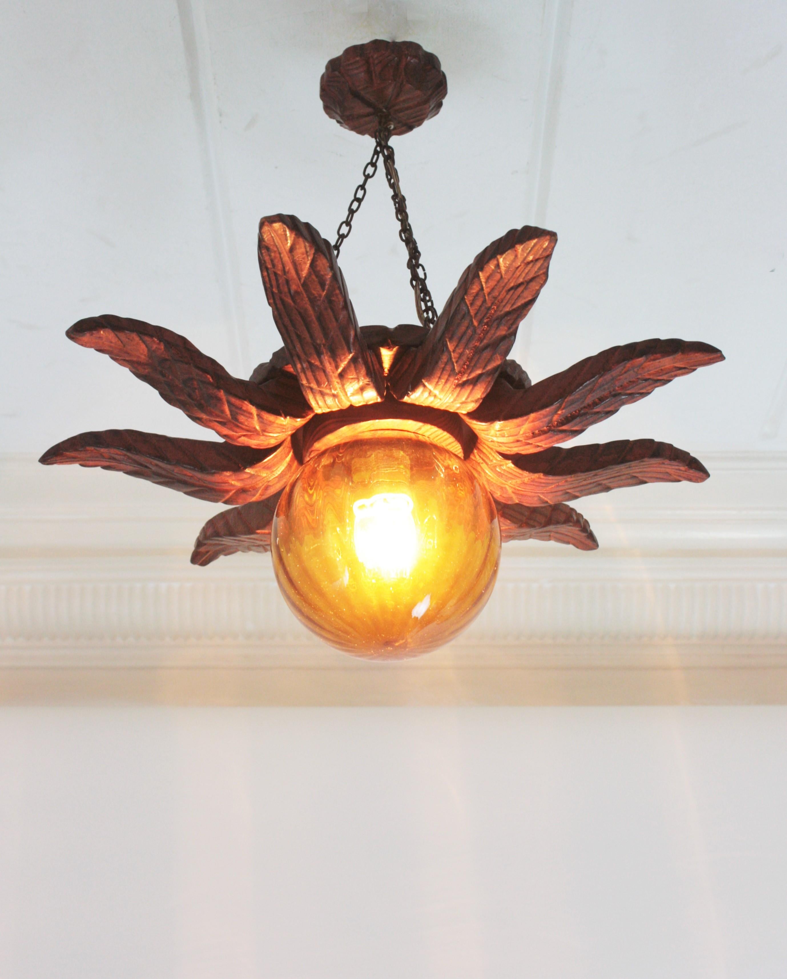 Spanish Colonial Sunburst Light Fixture in Carved Wood with Amber Glass Globe For Sale 3