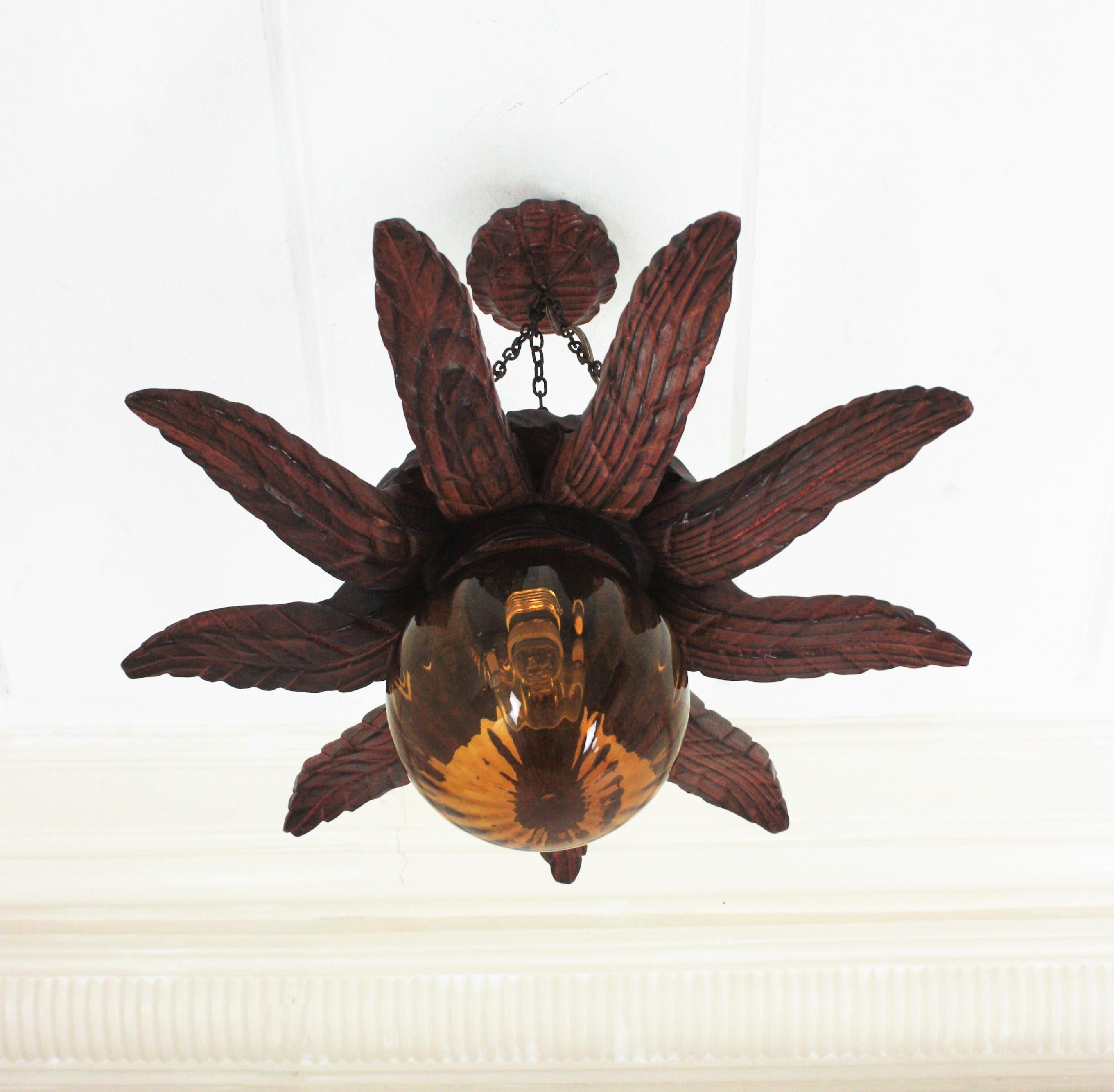 Spanish Colonial Sunburst Light Fixture in Carved Wood with Amber Glass Globe For Sale 4