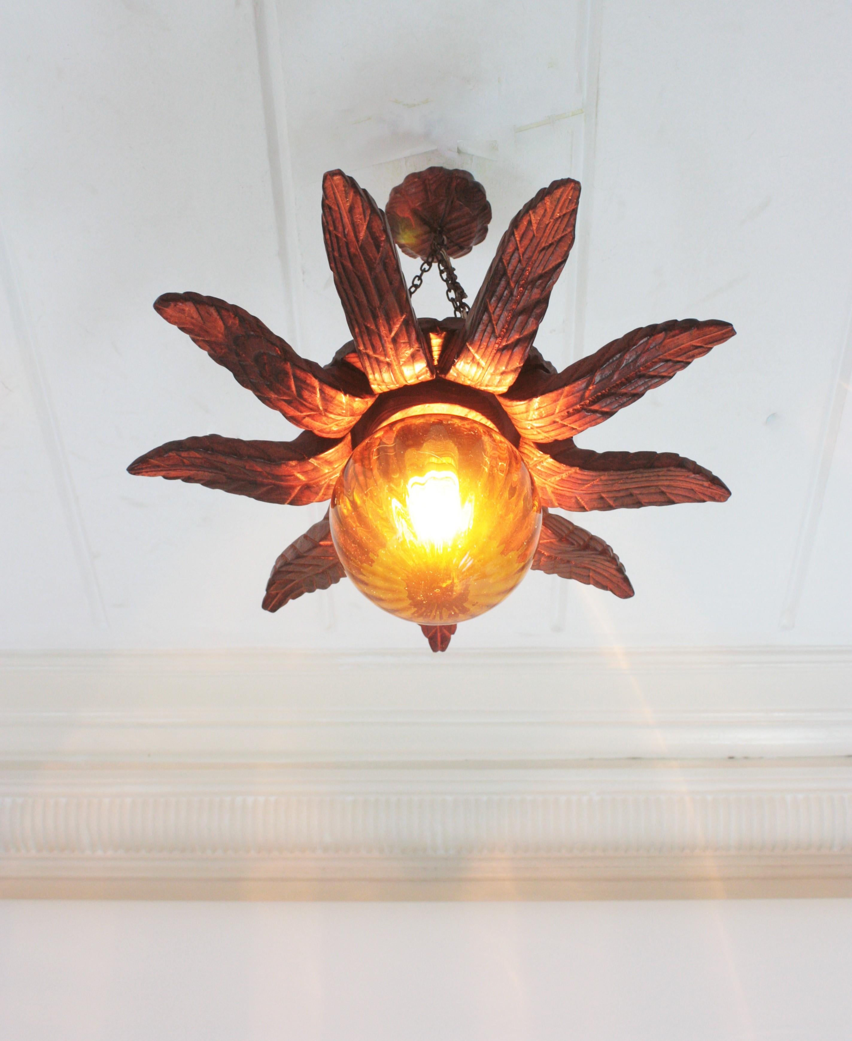 Spanish Colonial Sunburst Light Fixture in Carved Wood with Amber Glass Globe For Sale 5