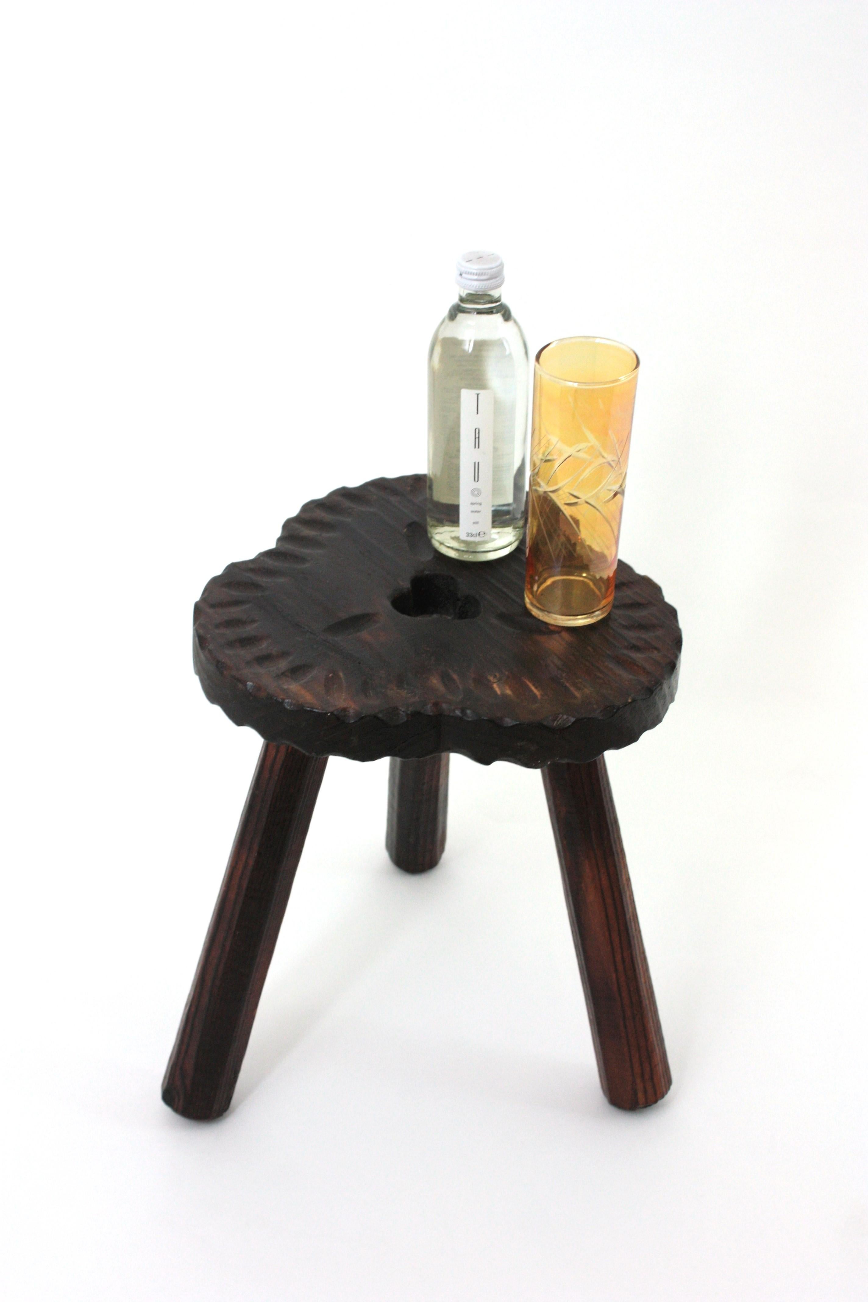Carved Wood Tripod Stool / End or Side Table, Spain, 1940s-1950s
The top has scalloped carving accents and a 3 leaf clover carved detail. It stands up on thick wooden legs.
This stool has a rustic finish and spanish colonial accents.
It will be a