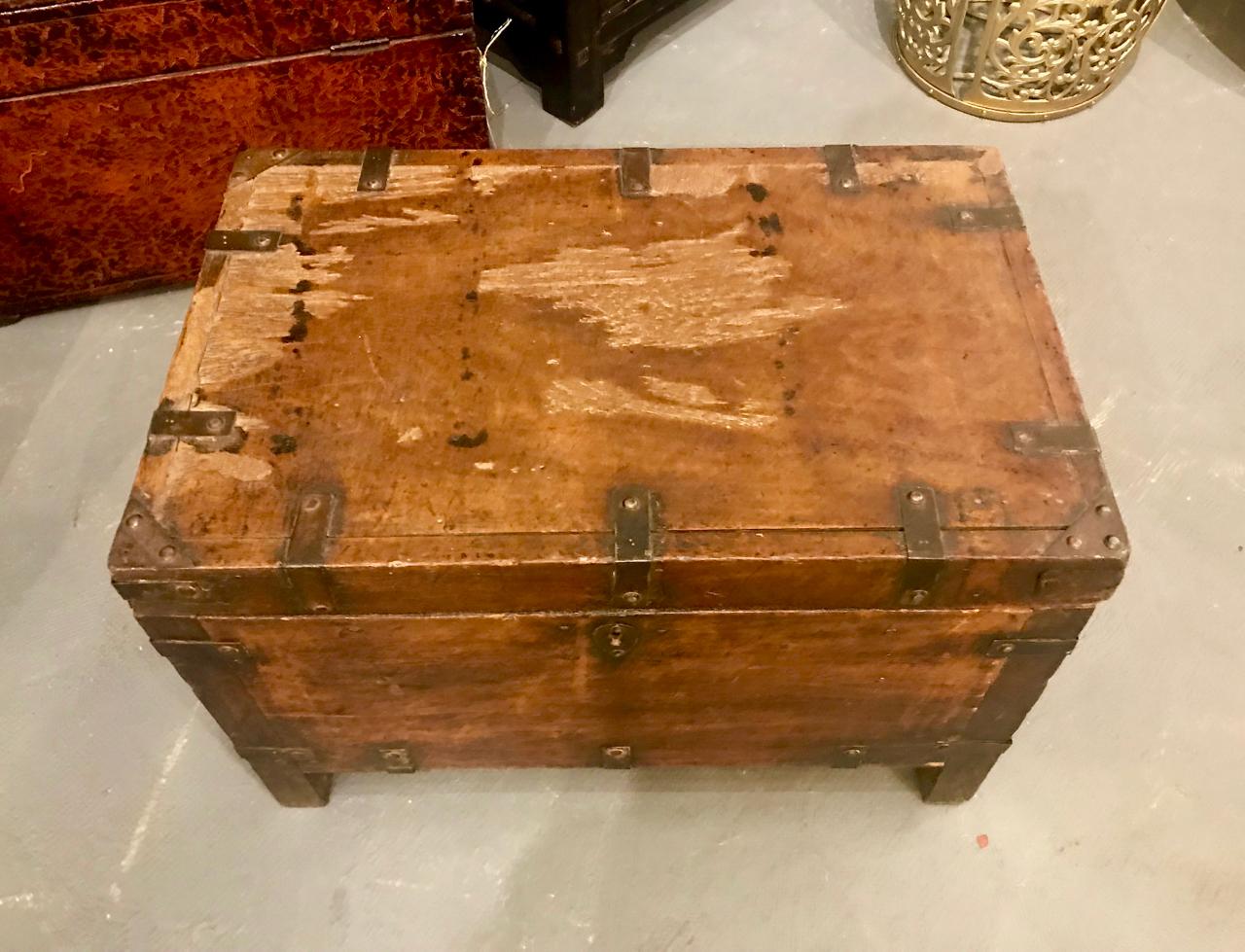 This is a charming 19th century Spanish Colonial, perhaps Mexican, trunk with iron strapping and its original lock. The trunk retains its original patinated surface and is in overall good condition.