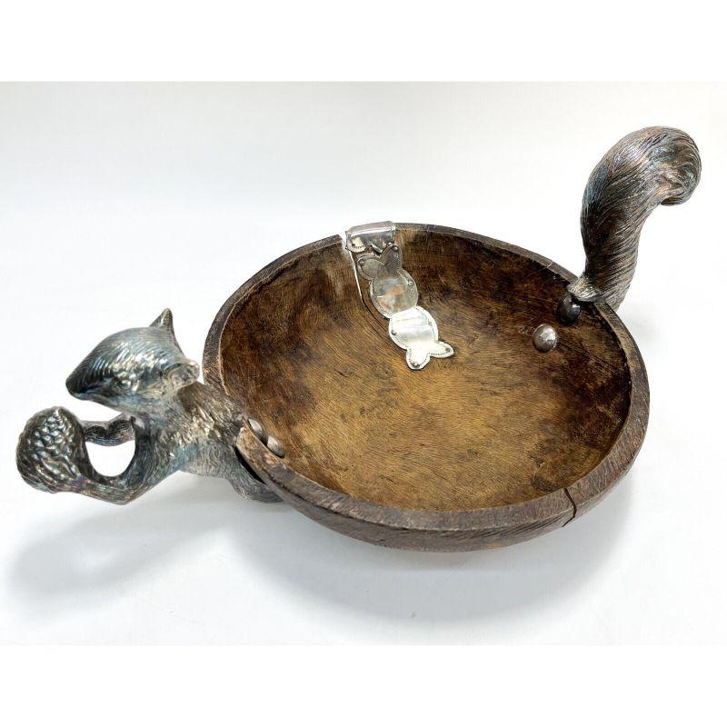 Spanish Colonial Turned Wood Solid Silver Squirl bowl

Spanish Colonial turned wood and solid silver mounted squirrel bowl. Thick turned wood bowl with attached solid silver squirrel head and tail, as well as a shaped silver band to the side and