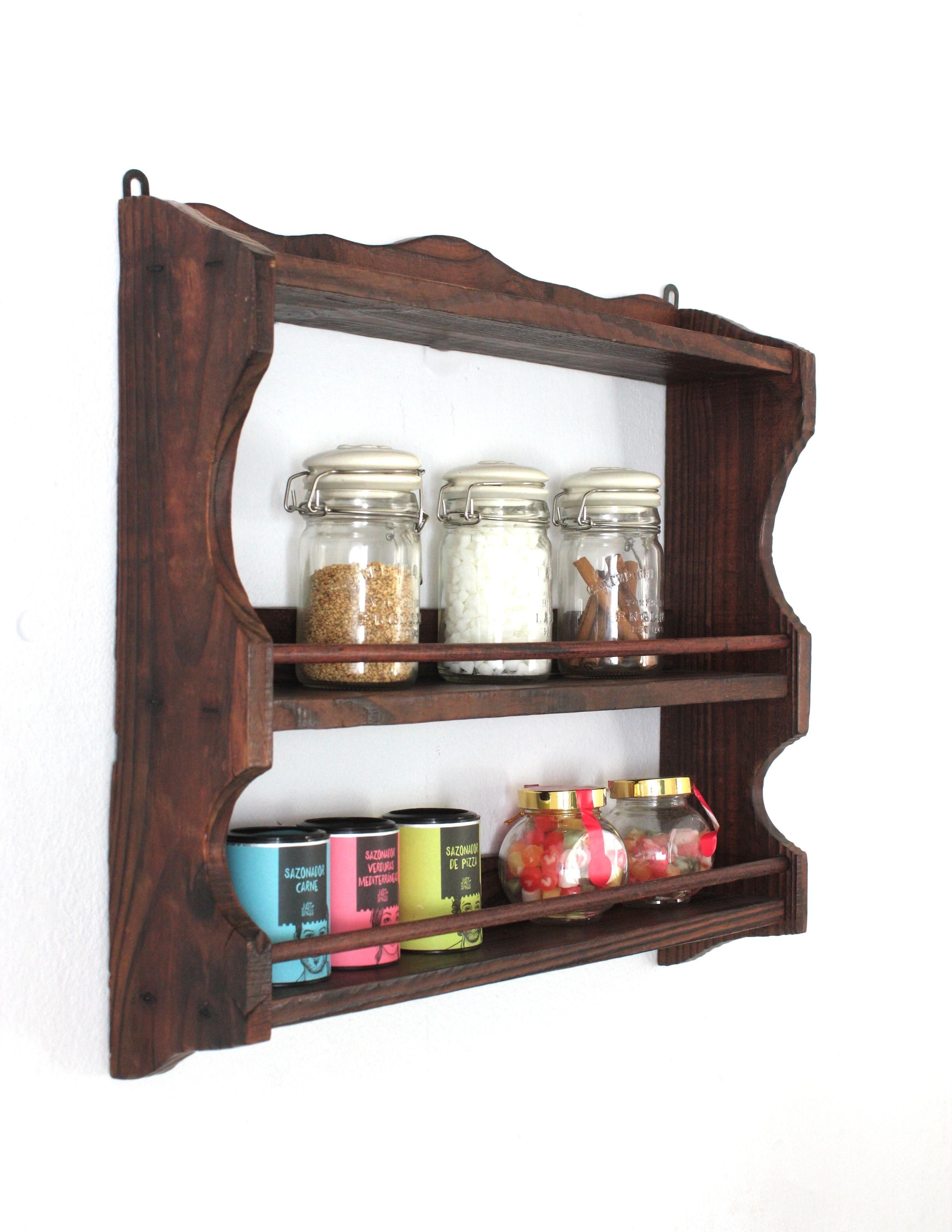 Spanish Colonial Wood Spice Rack Wall Shelf, 1940s
Hand-carved pine spice rack or wall shelf, Spain, 1940s-1950s
This spice rack shelf has scalloped and carved details and decorative iron nails
it has a rustic finish and Spanish colonial accents.
It