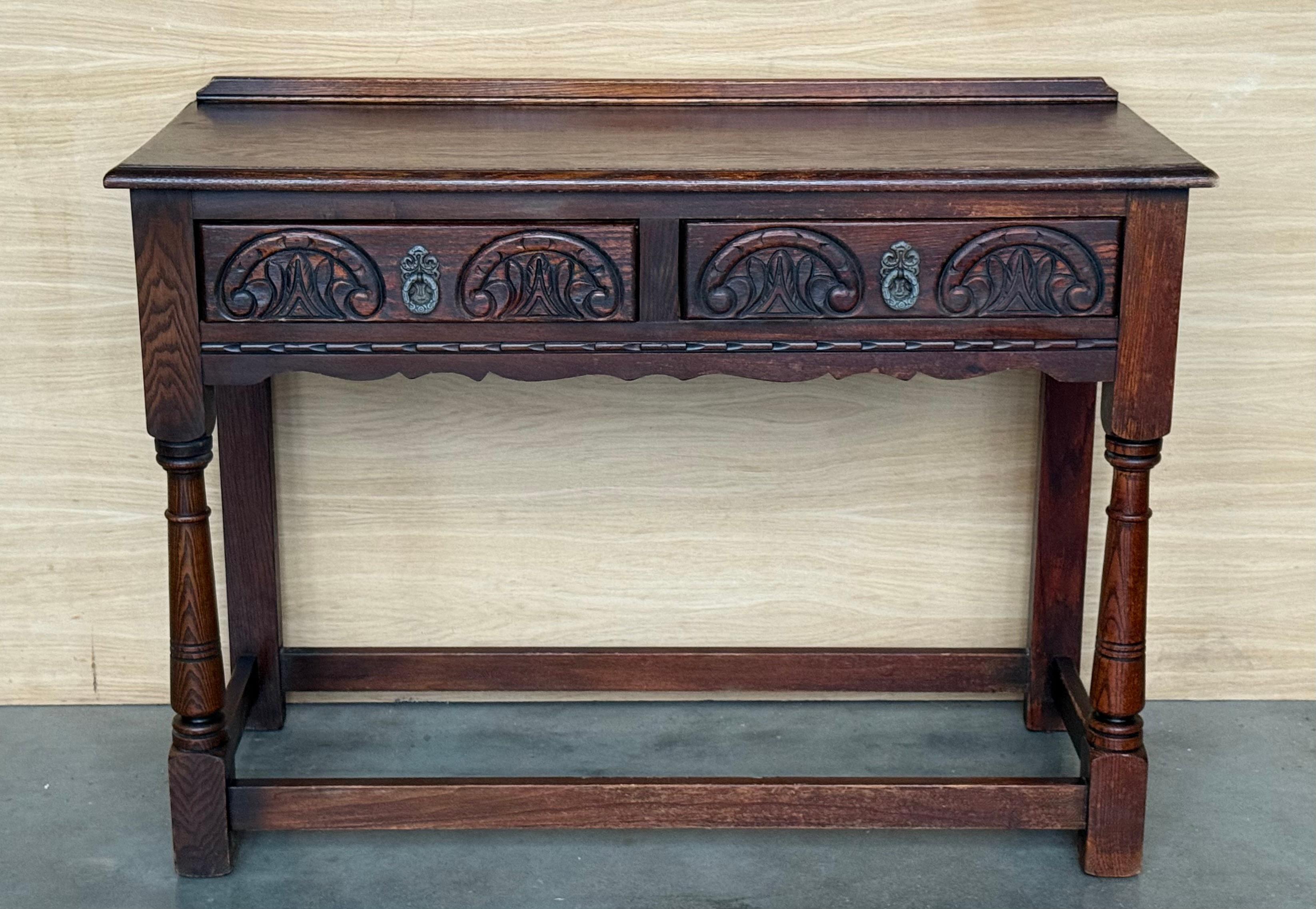 Spanish Country side table with two carved drawers. Made of antique walnut, this table is very functional and you can use like a desk, sofa table, coffee table or  console.
In the drawer you can see the leaf carved.


Height to the crest :