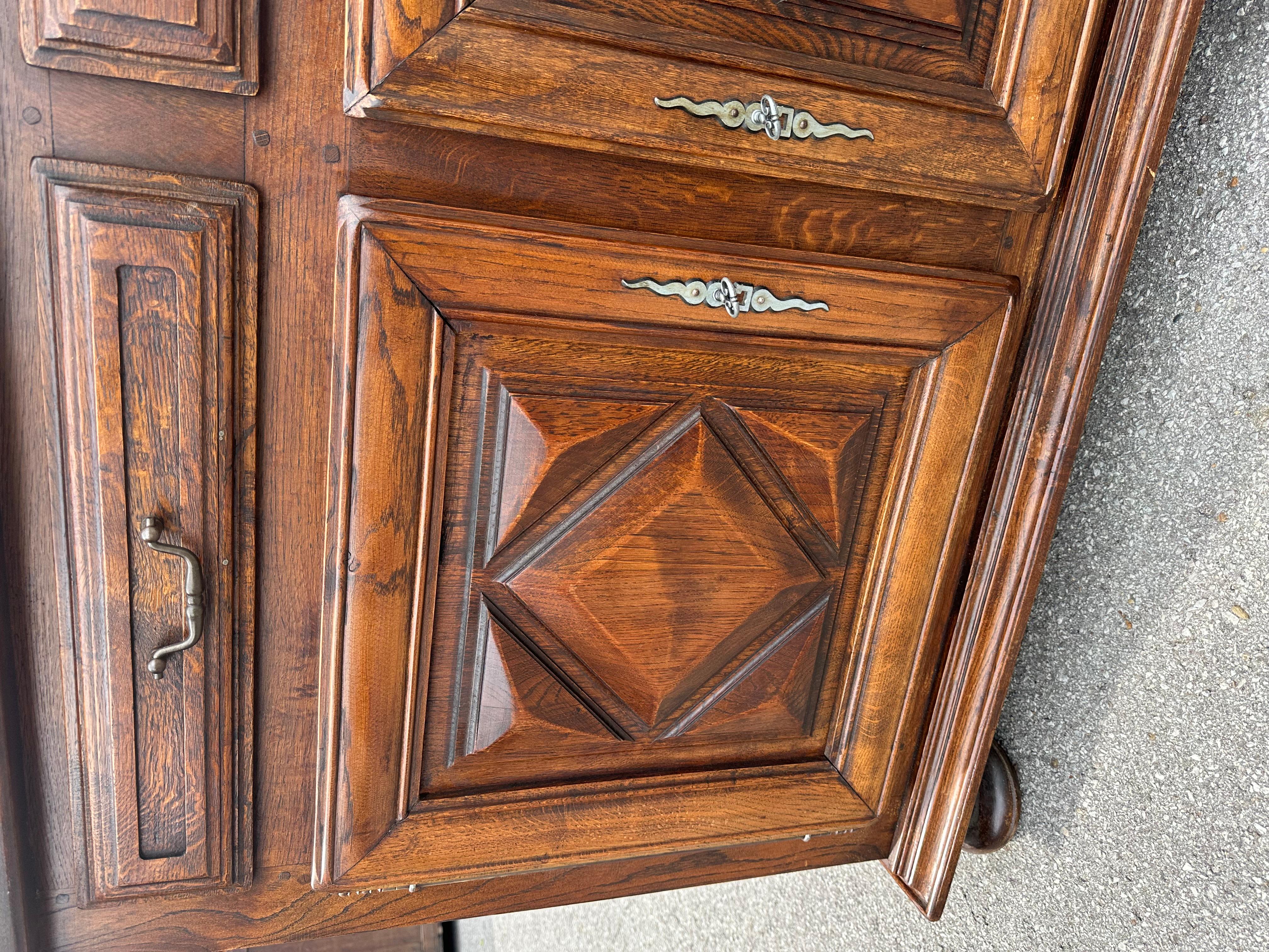 This is a great Spanish server featuring a geometric front raised panels on the ends. The shallow depth makes it especially attractive. And excellent piece with all drawers and doors in perfect condition