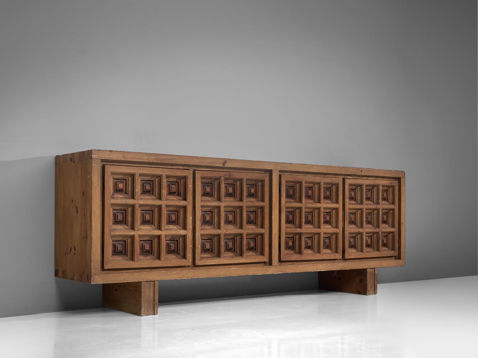 Biosca, sideboard, stained pine, Spain, 1960s.

Outstanding Spanish sideboard that is executed by Biosca in a beautiful way. The four-door credenza features doors with a graphic carved pattern. This is very typical for Brutalist style, while the