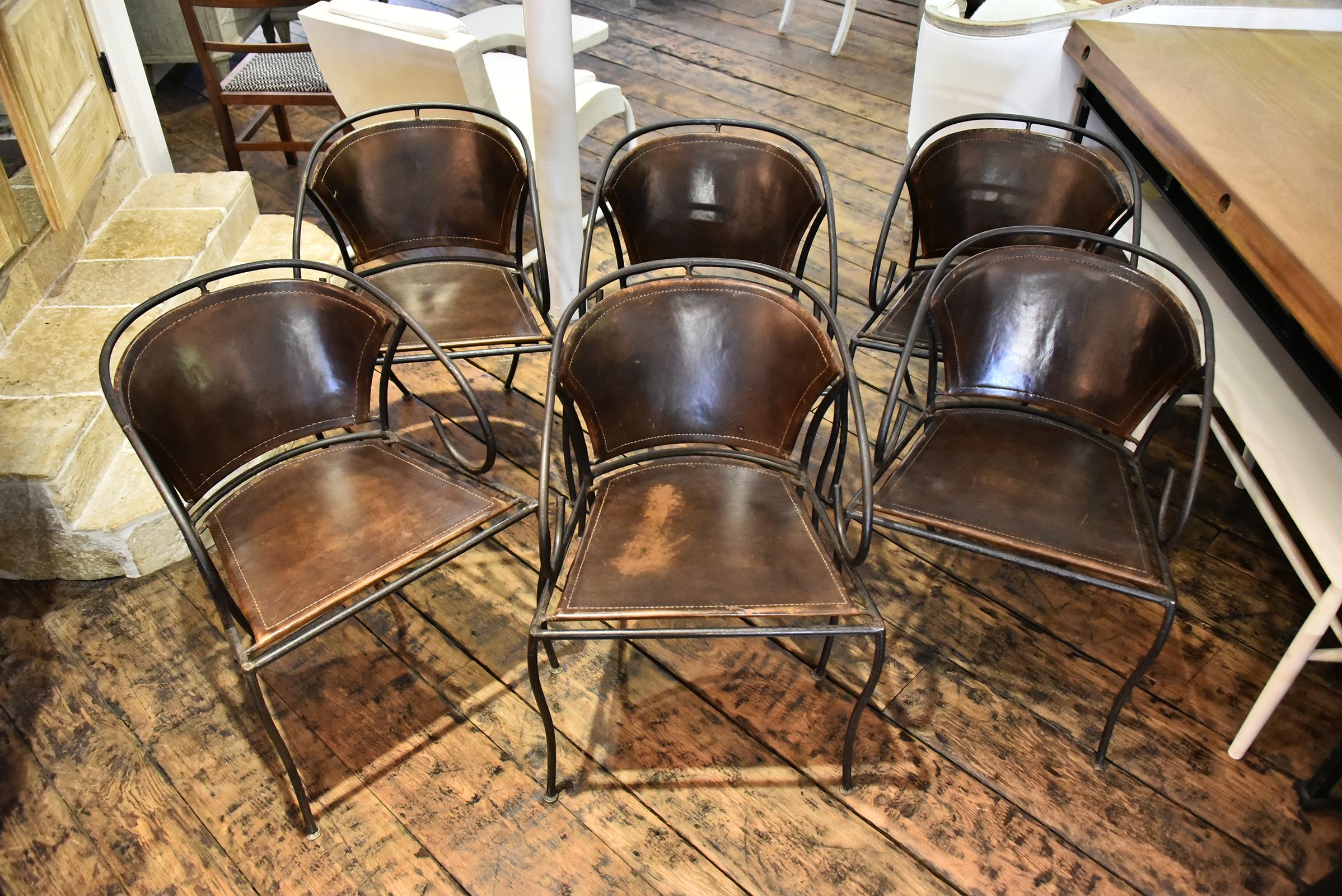 A set of 6 iron and leather Spanish chairs with authentic patina. Signs of age on some of the leather.