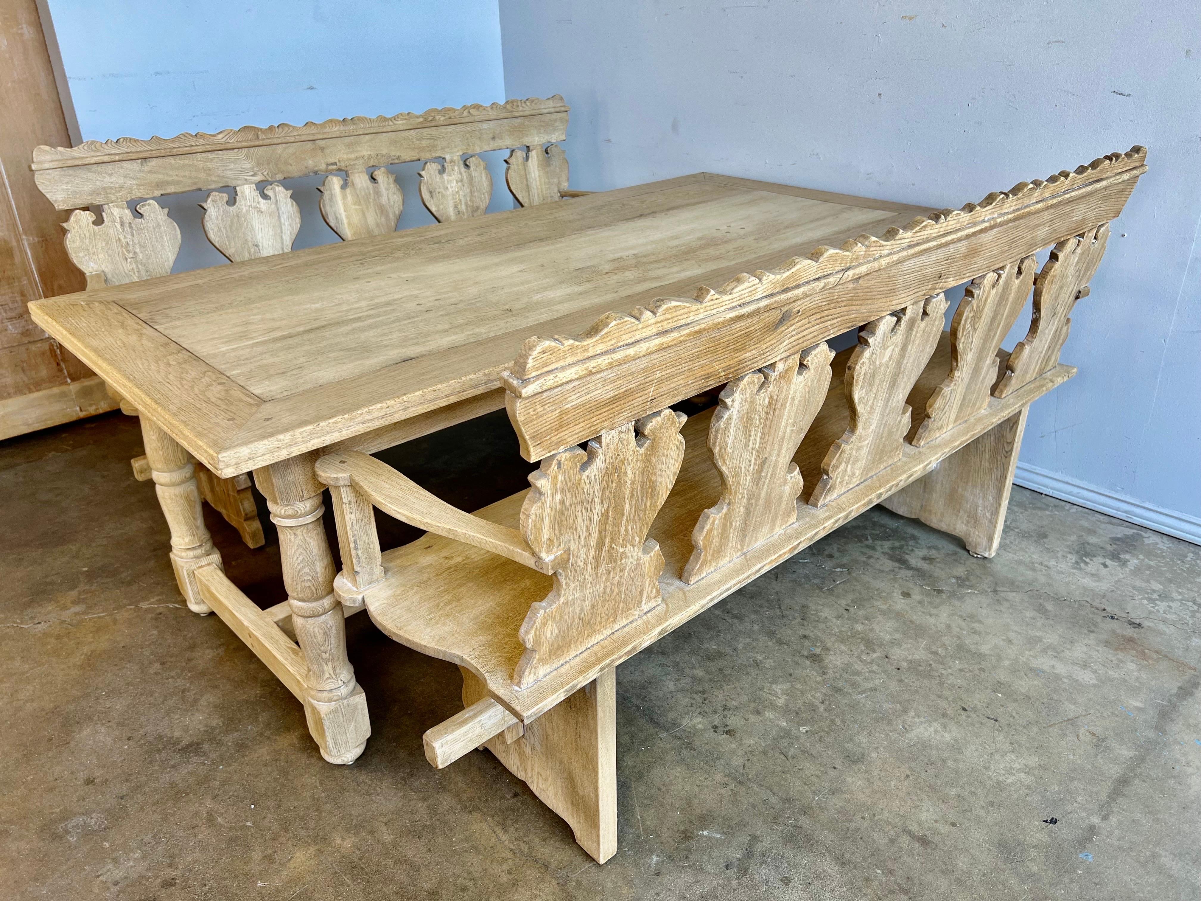 Dining set comprising of a bleached oak Spanish Trestle table with coordinating bleached oak Spanish Baroque style benches. Beautifully hand constructed with original wood pegs and joints.