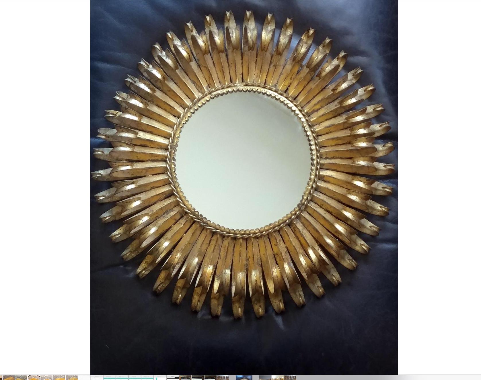 A hand forged iron vintage double tiered sunburst mirror from Spain.
Lovely patina wrought iron, gilt surface throughout. 
Circa 1950s in the Brutalist style.
The original Made in Spain tag intact.
The backing has been replaced due to old age