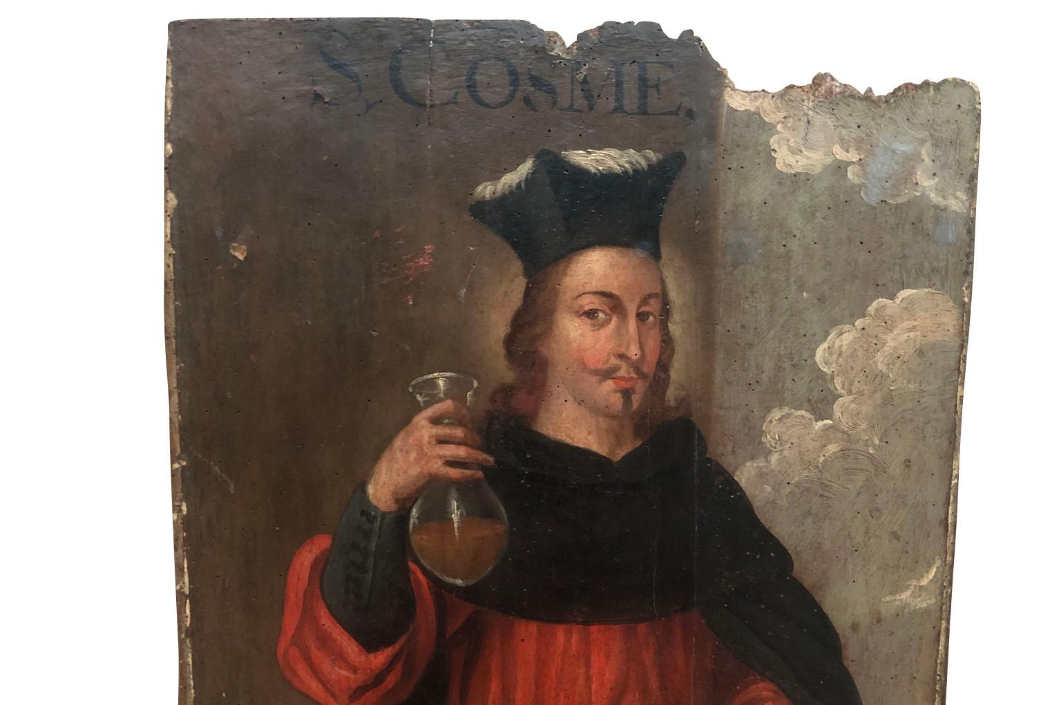 A wonderful Spanish early 17th century painting on board of Saint Cosmas. Legend has it that St. Cosmas and his twin brother Damian, were skilled doctors and treated the sick without charging for their services. Saint Cosmas and Saint Damian are the