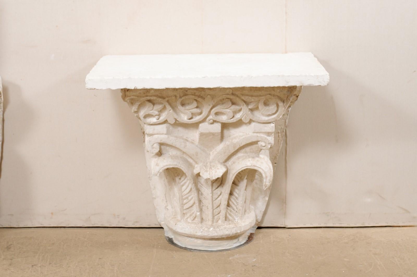 A Spanish console table from the early 20th century with newer fossilized coral top. This beautiful, custom console table has been fashioned from an antique base from Spain, consisting of a unique and architecturally inspired, scrolling leaf design