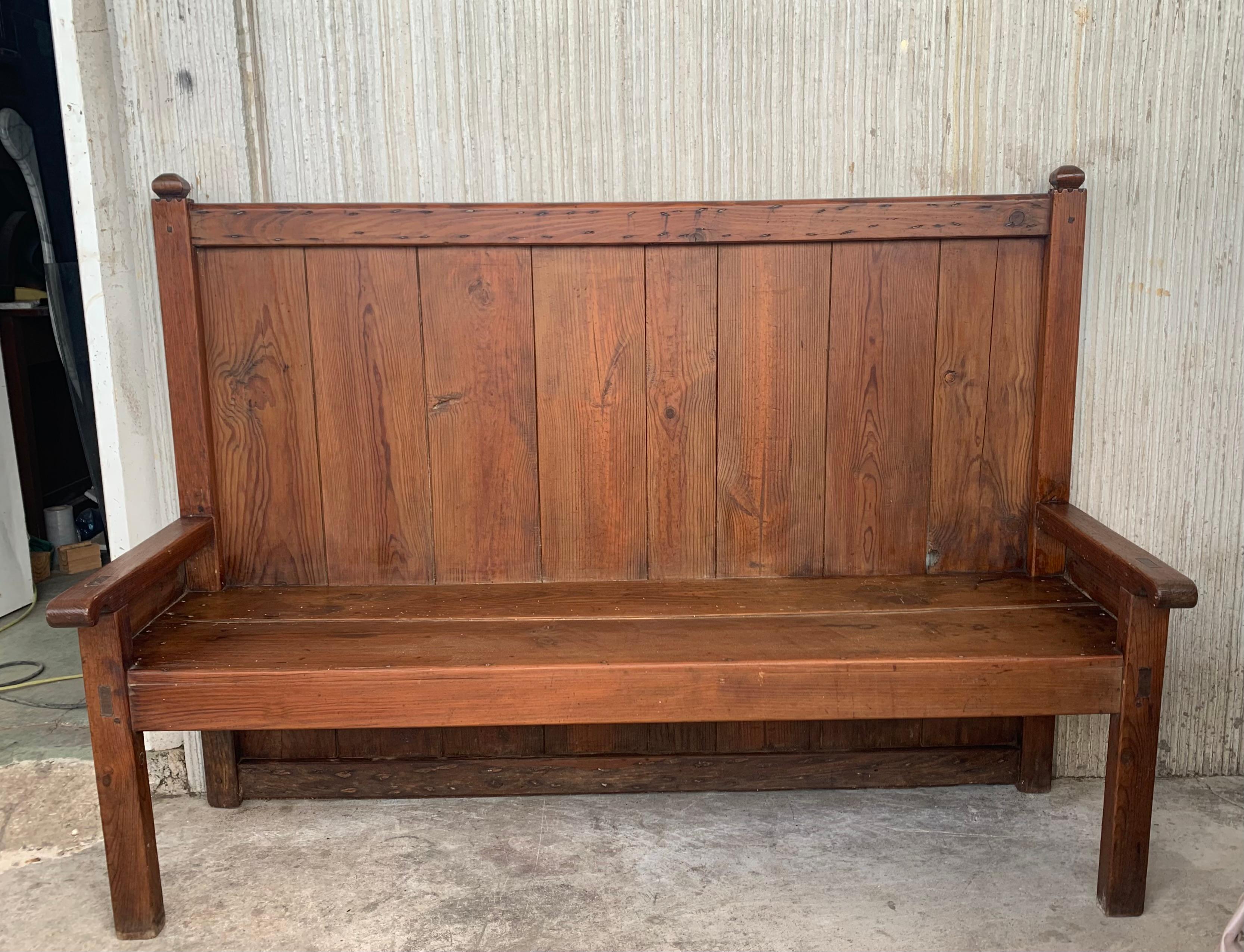 This is a Spanish, pine, bench with honey patina. It is dove tailed and a sturdy, rustic piece that would be idea as a hall bench or many other uses in your home or covered patio.

Height to the arms: 22.83in.