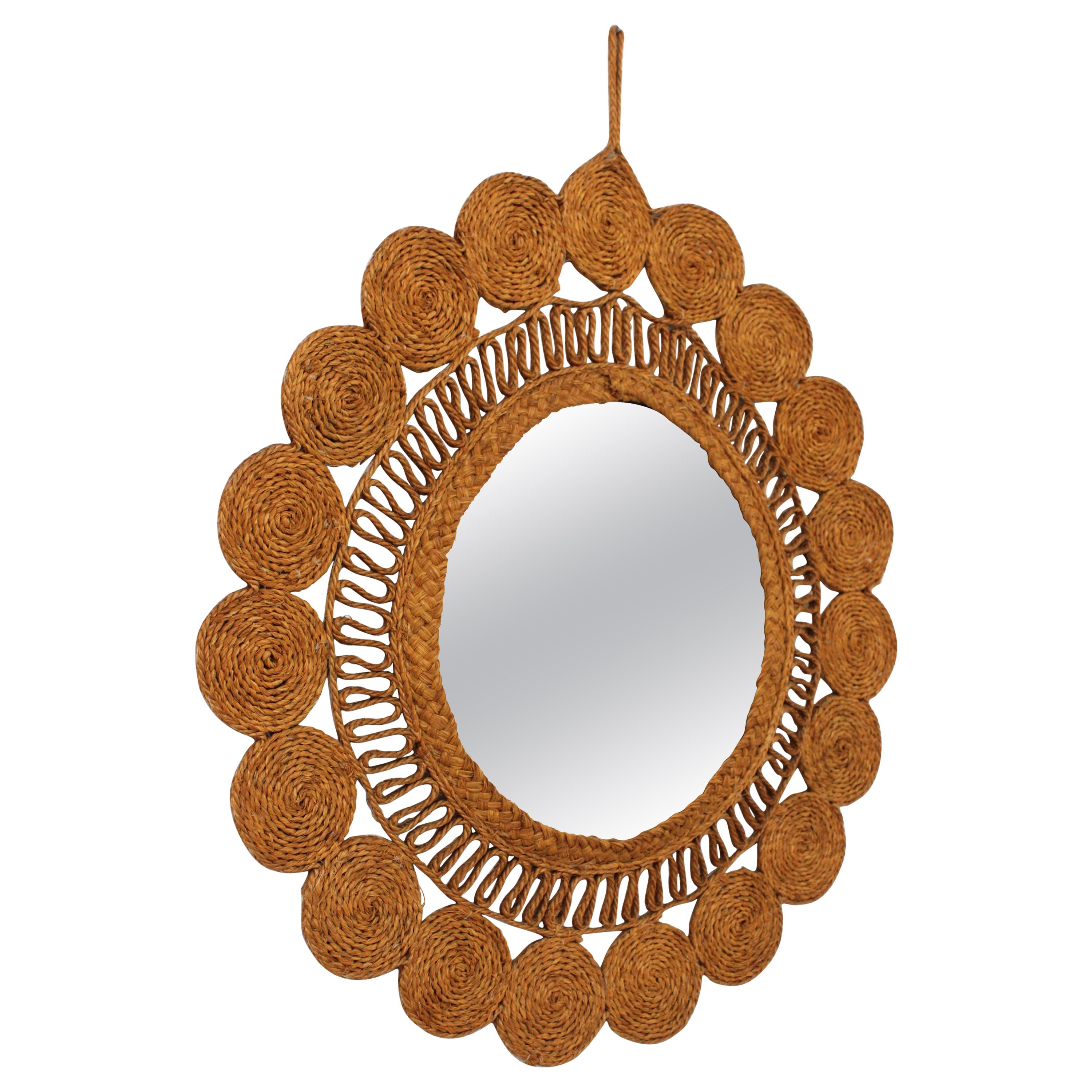 Artisan Handwoven rustic wall mirror, esparto grass and rope, Spain, 1960s
This artisan mirror is made with esparto natural fiber. It features a sunburst or flower shaped frame surrounding a circular glass. A wavy rope pattern highligts the beauty