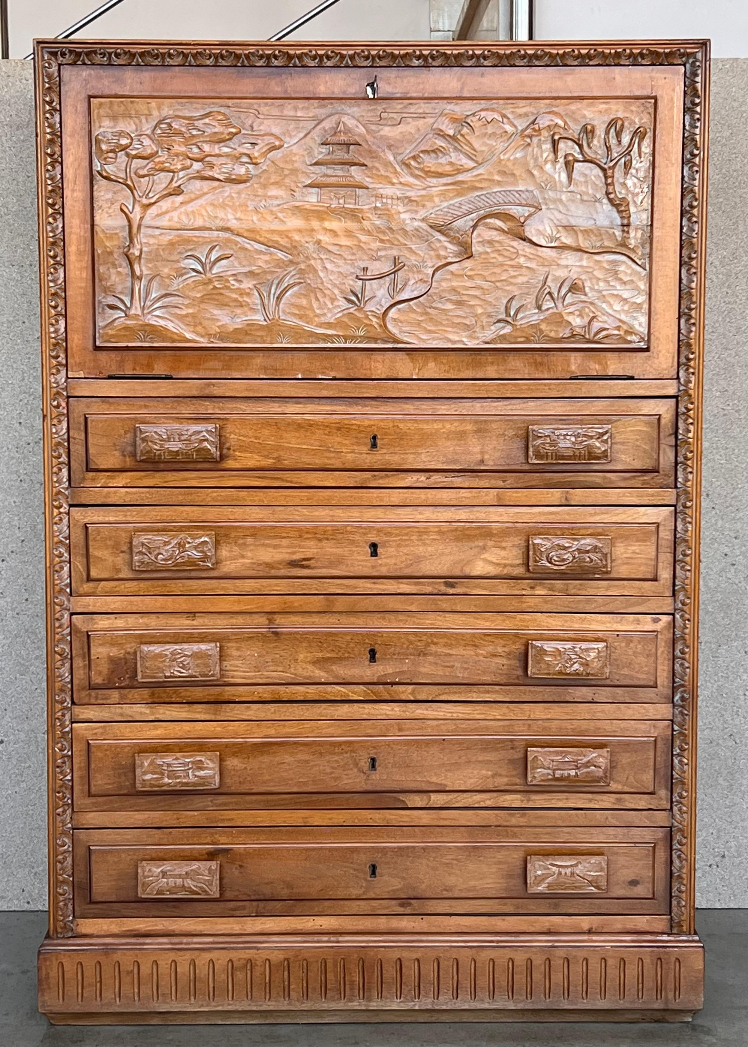 Mid 20th century walnut Spanish fall-front secretary with molded carvings in drawers and doors.


Measures: Height from the floor to the open leaf: 32.40in.
