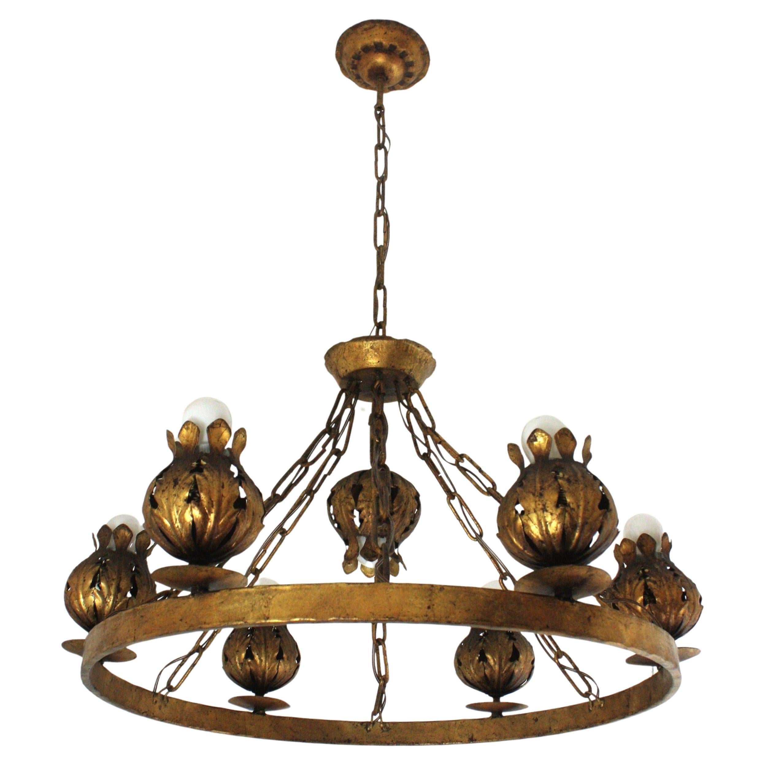 
Outstanding spanish floral seven-light ring chandelier in gilt iron, Ferro Art, 1950s
Large size ( 87 cm H x 69 cm diameter). 7 Lights.
Rare find.
This 7 light chandelier was entirely made by hand in wrought iron and finished in gold leaf gilding.