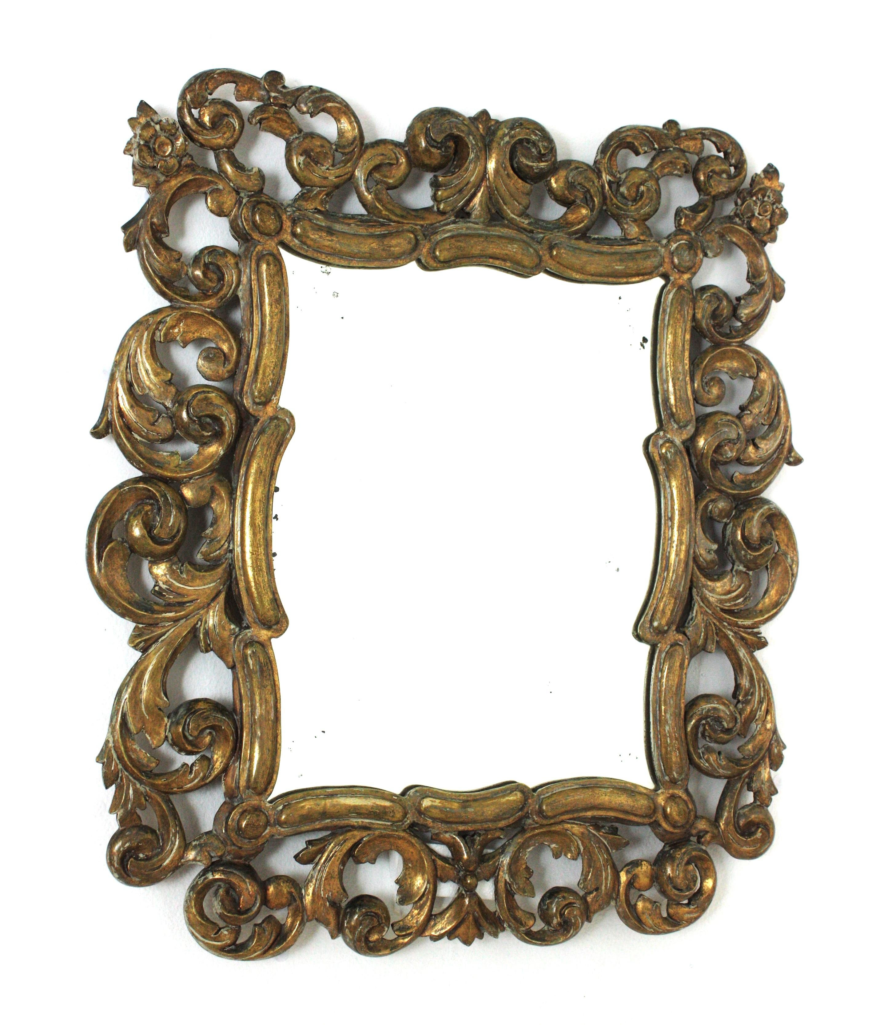 Finely Carved Giltwood Rococo Style Mirror, Spain, Early 20th century.
The frame is richly adorned with carved leaves, flowers and scrollwork details. It wears its original glass. It has a dramatic aged patina and gold leaf gilding.
Lovely to place