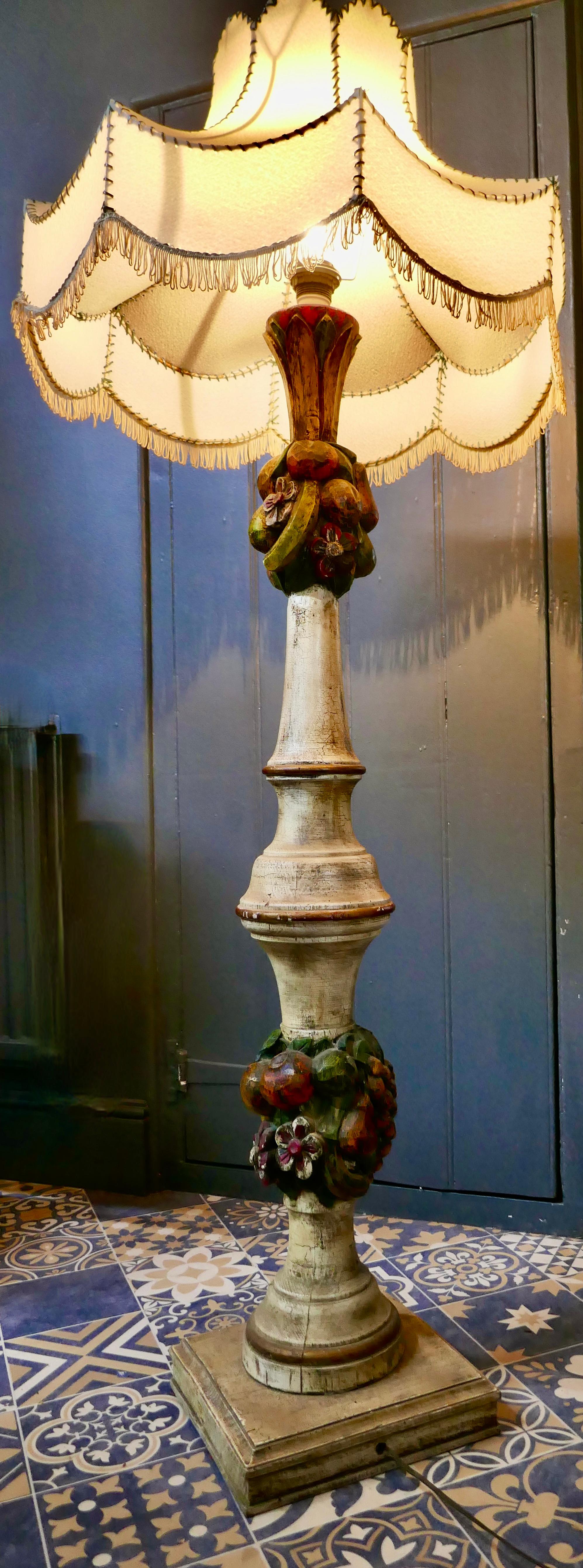 Spanish Folk Art floor standing standard lamp

 A traditionally turned, carved and painted piece from Spain. This wooden lamp stands on a square base, it is stepped at floor level and has a large bulbous shape decorated with carved and painted