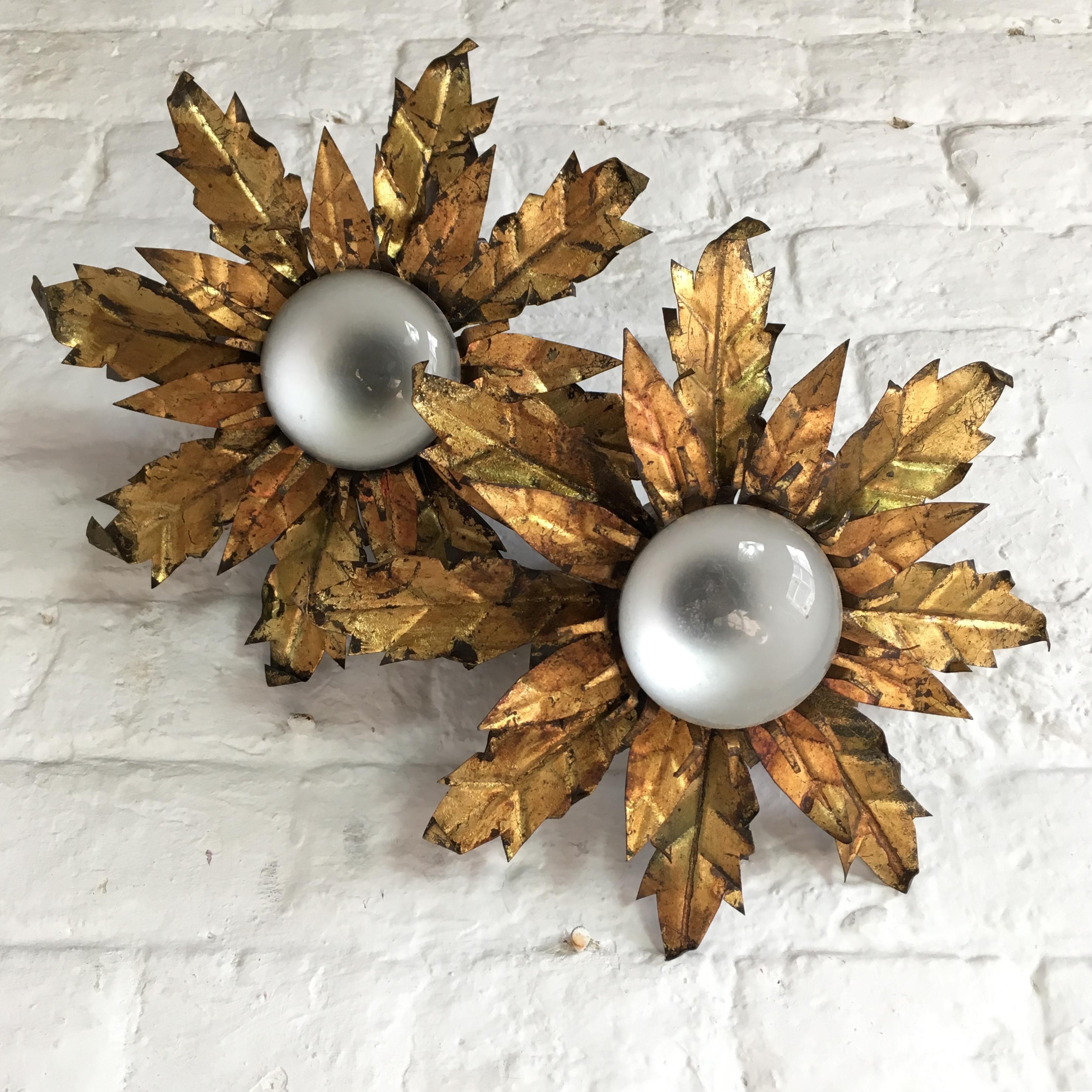Spanish crown flush light, circa 1950s. Gilt metal. Priced individually, per light. Two layers of handcrafted textured metal leaves set around a centre crown of metal stamens which surround the bulb. The light takes one single bulb to the centre.