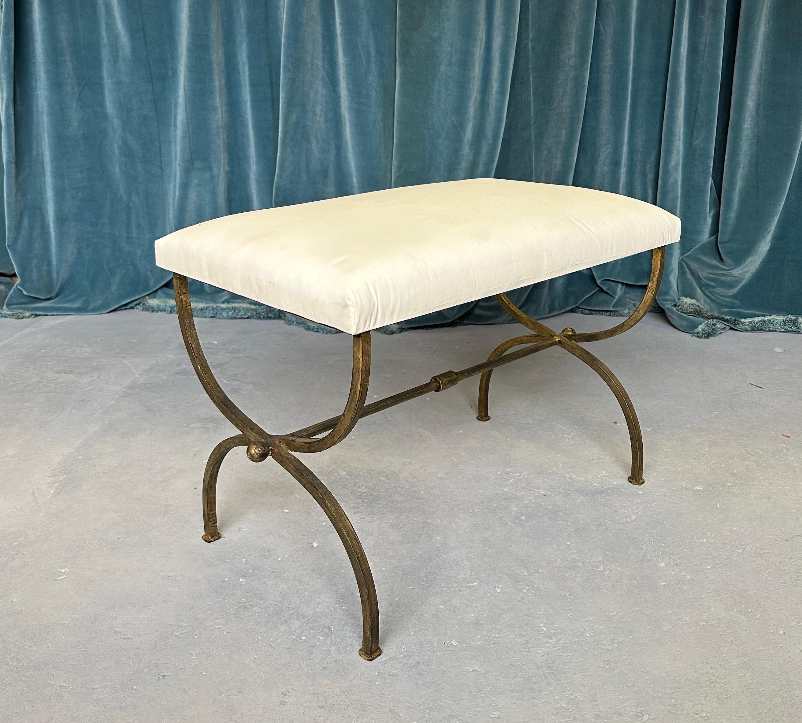 This lovely iron bench was recently made by skilled European craftsmen and features gracefully curved legs and a central stretcher with a decorative central ring detail and spheres at the ends. Handmade by expert artisans, it has a hand forged iron