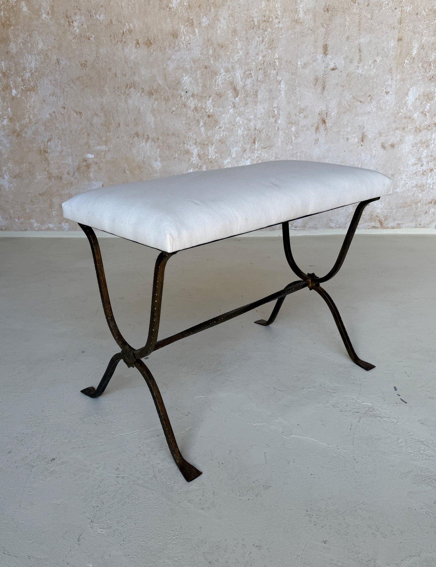 This exquisite Spanish gilt iron bench was recently crafted by skilled European artisans using traditional iron-working techniques and materials. The hand forged inverted double u shaped base has a hammered texture and features a slightly twisted