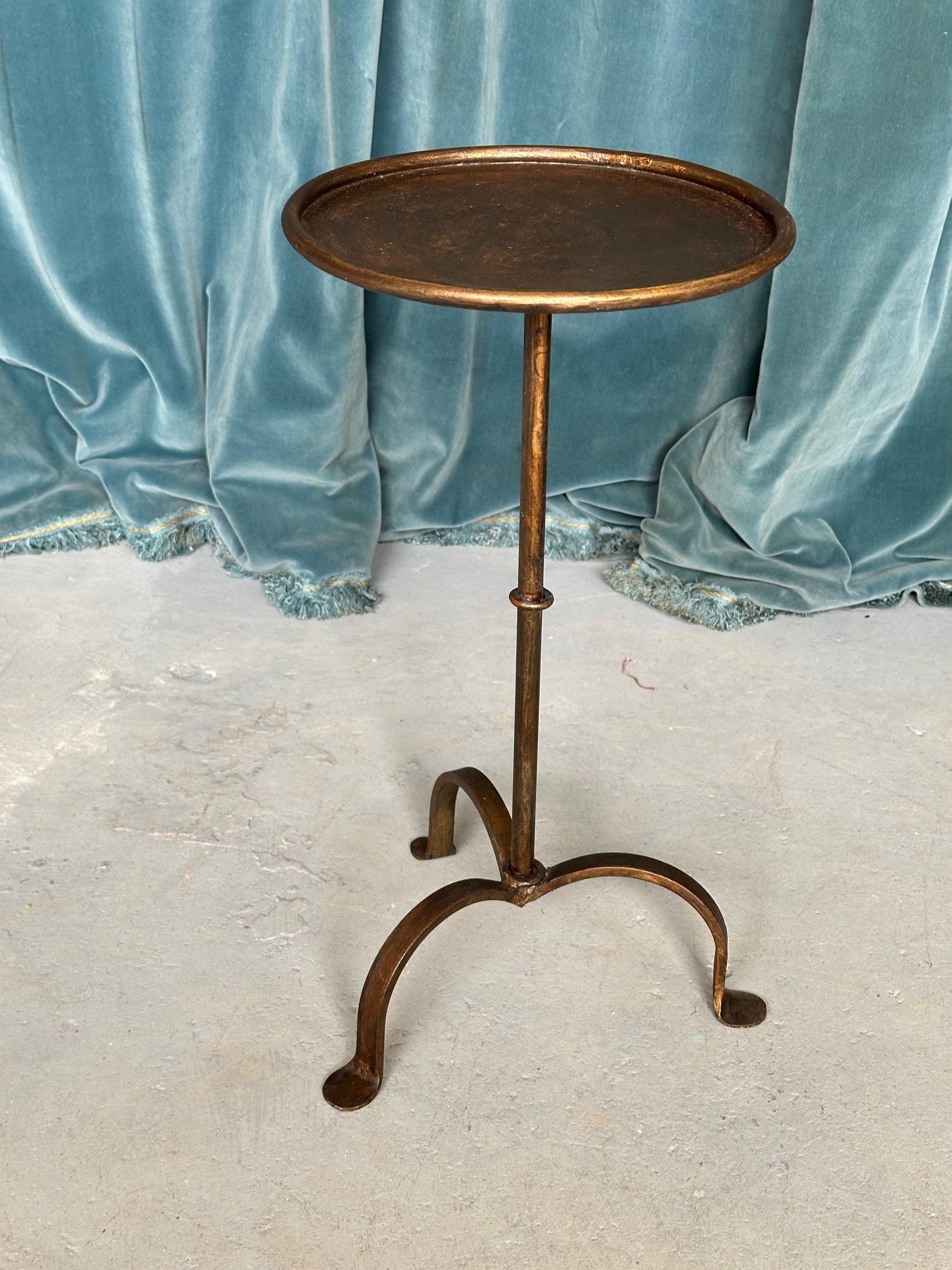 This elegant small end table was recently created by skilled European artisans using traditional iron working techniques. Hand-forged from iron, it features a stem with a central ring detail mounted on a sturdy tripod base with curved legs. A rolled