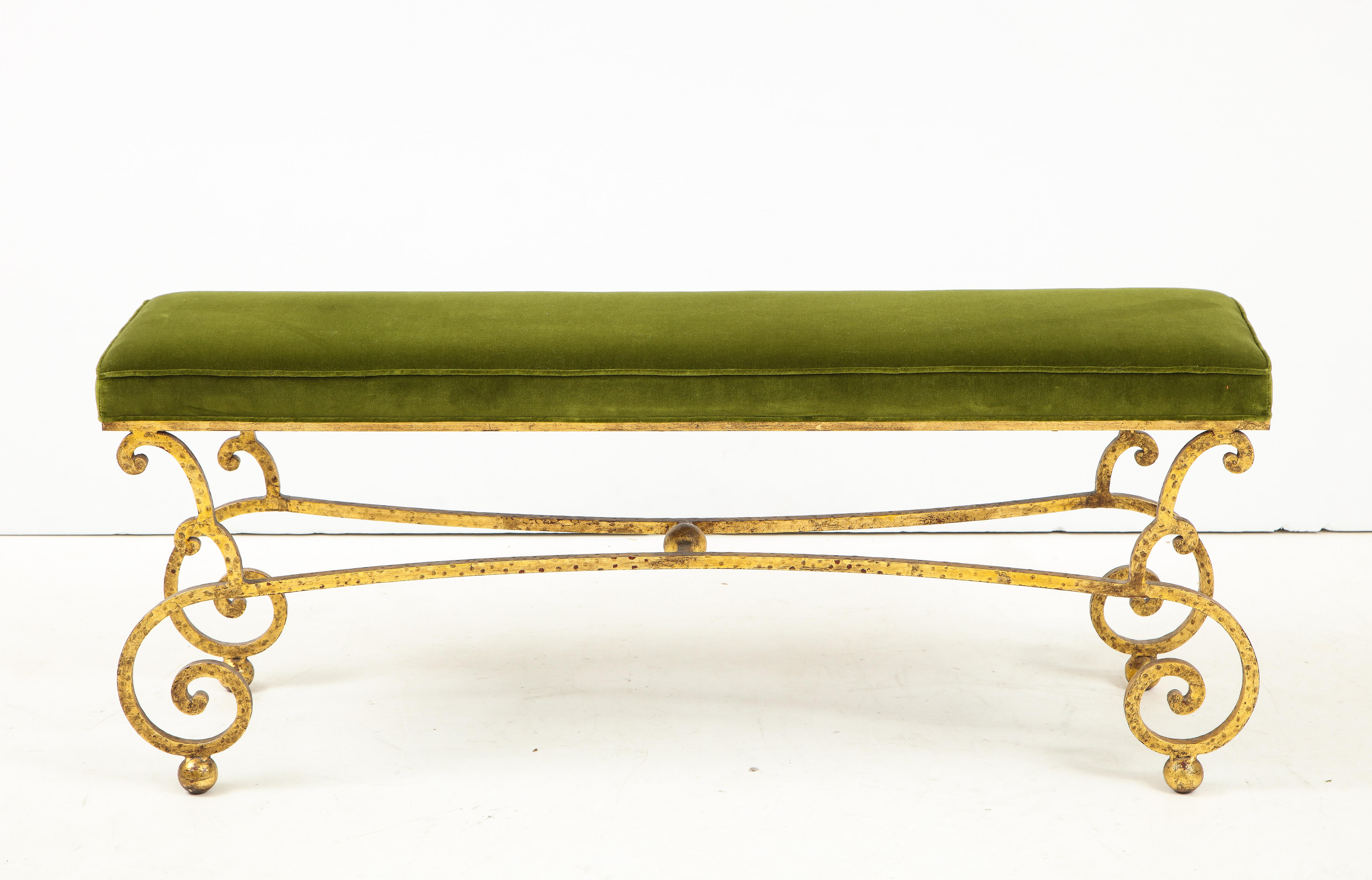 A Spanish gilt iron hammered bench supported by elegantly scrolled legs atop ball feet. Upholstered in a rich moss green. Perfect for an entry hall or the end of a bed!
Spanish, circa 1950
Size: 19