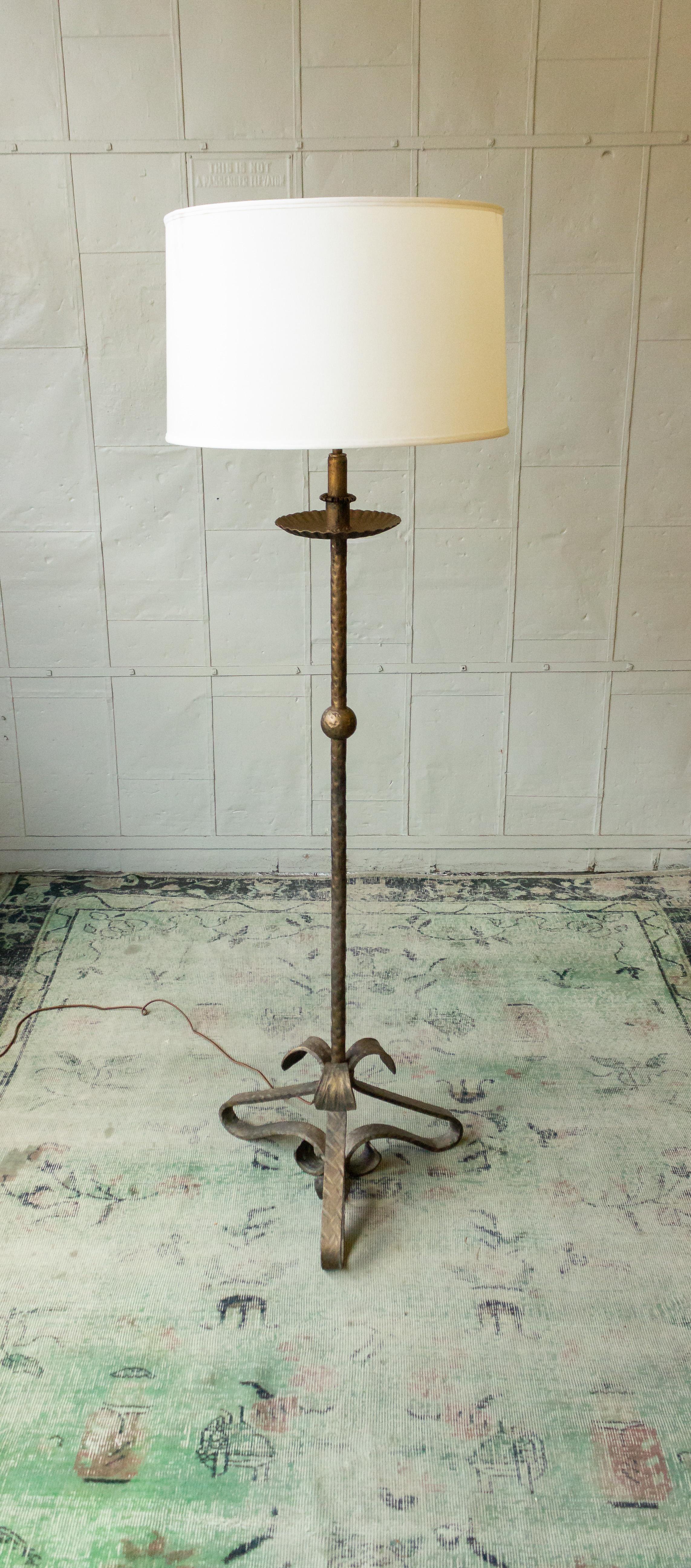 Introducing a captivating 1950s Spanish floor lamp that effortlessly combines the elegance of Art Nouveau with the sleekness of mid-century modern design. This remarkable piece is a true work of art, sure to captivate the hearts of design