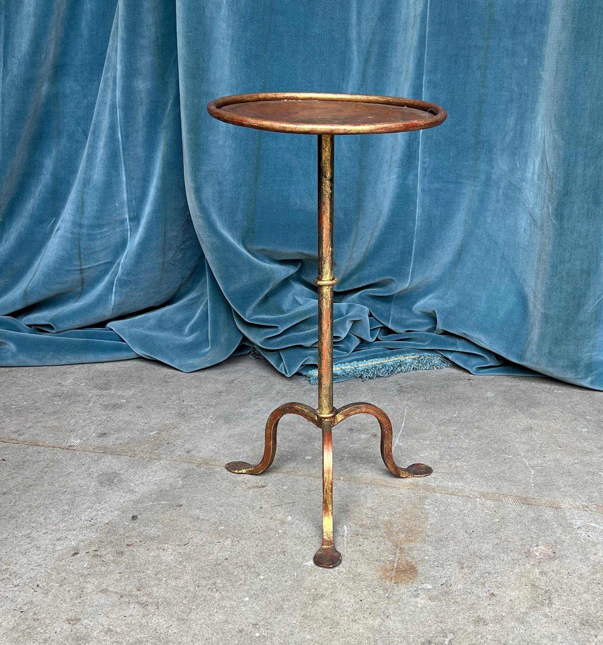 This handsome gilt iron martini table was recently created by accomplished artisans using traditional iron-working methods with an emphasis on superior quality. Giving meticulous attention to detail, it features a beautiful patinated finish that