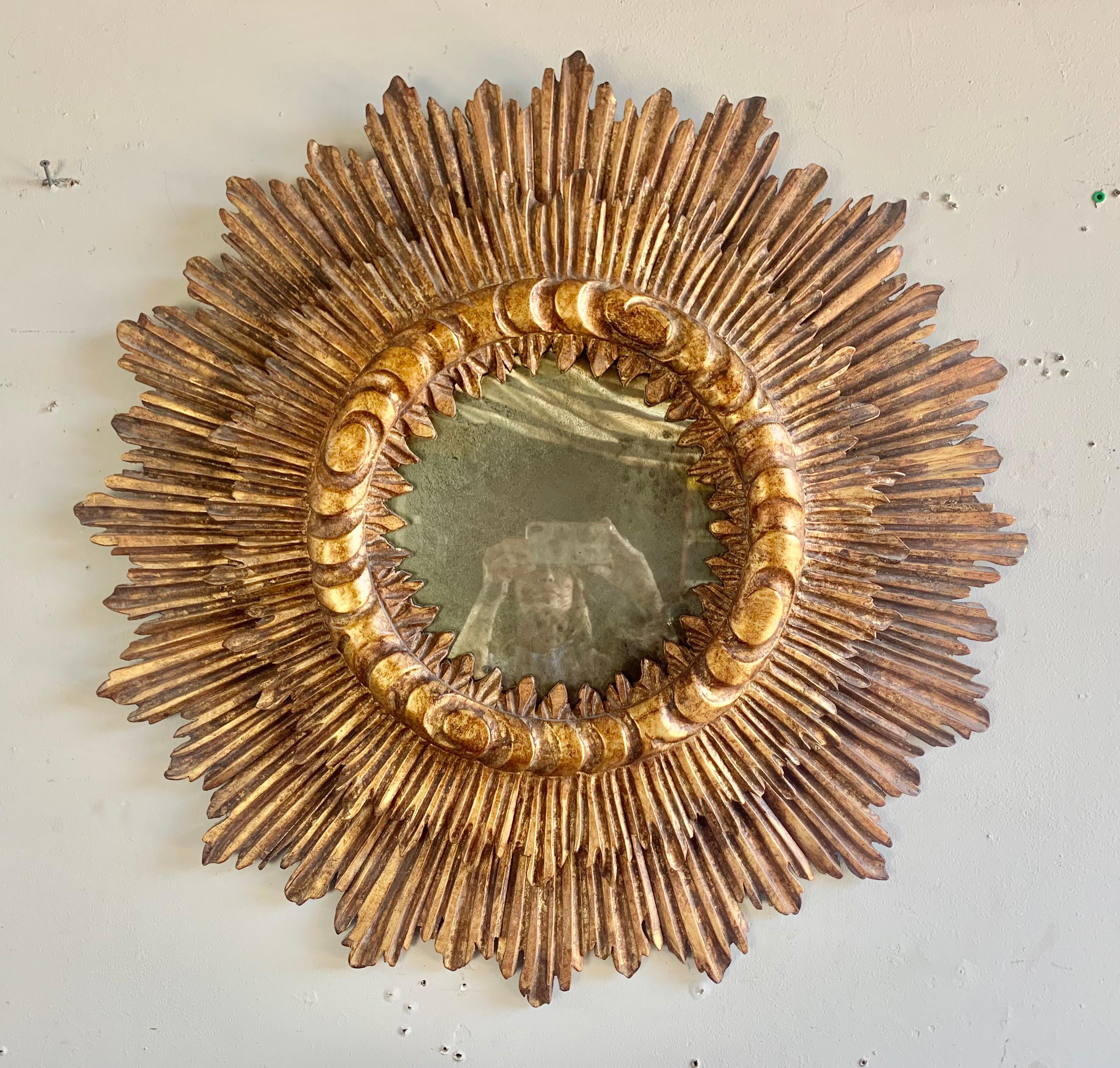 Spanish gilt wood carved sunburst mirror with a unique design.