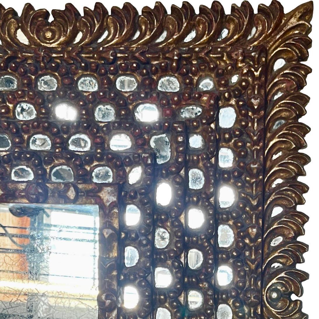 A circa 1940's Spanish gilt mirror with mirror insets.

Measurements:
Height: 27