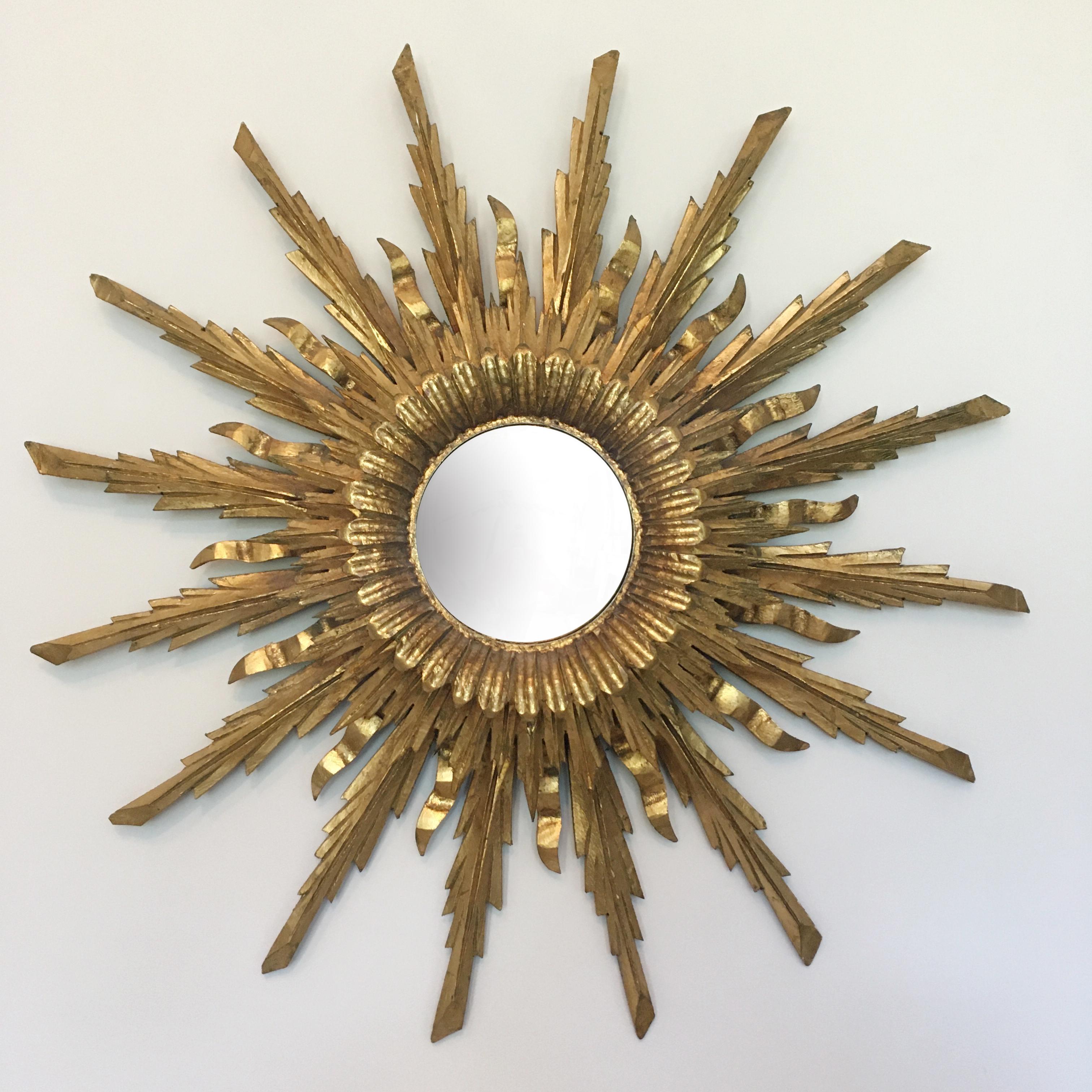 Spanish handcrafted triple layer wooden sunburst mirror with lights
Beautiful triple layers of wooden handcrafted gilt rays
circa 1930s
Original convex mirror
The glow of the backlighting is incredible
Hand carved wood with original gilt
