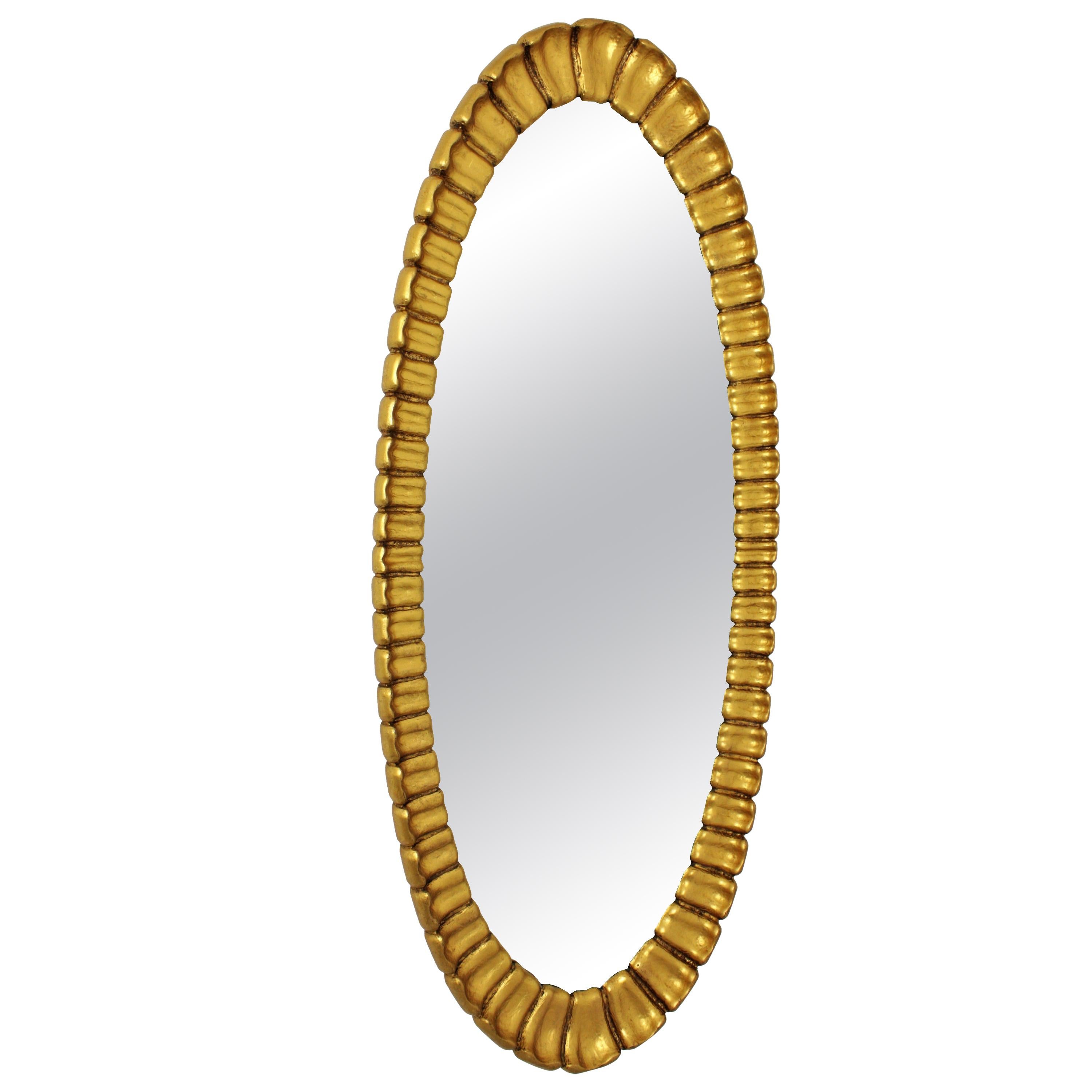 Large 1950s Hollywood Regency carved giltwood oval mirror with scalloped frame.
Designed and manufactured by Francisco Hurtado.
Labeled at the back.
This elegant mirror will be the perfect choice to add a luxury midcentury accent in a dressing