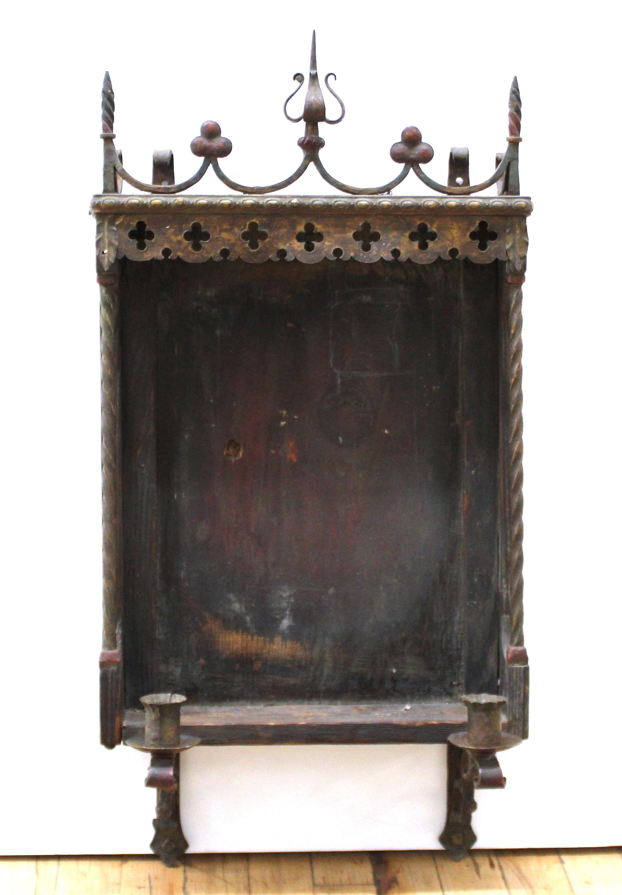 Spanish Gothic Revival wooden wall-mounted niche frame or altar with ornamental wrought iron elements and a pair of candle sconces. The piece can be used to house a painting or a mirror. Handmade in Spain during the mid-19th century.