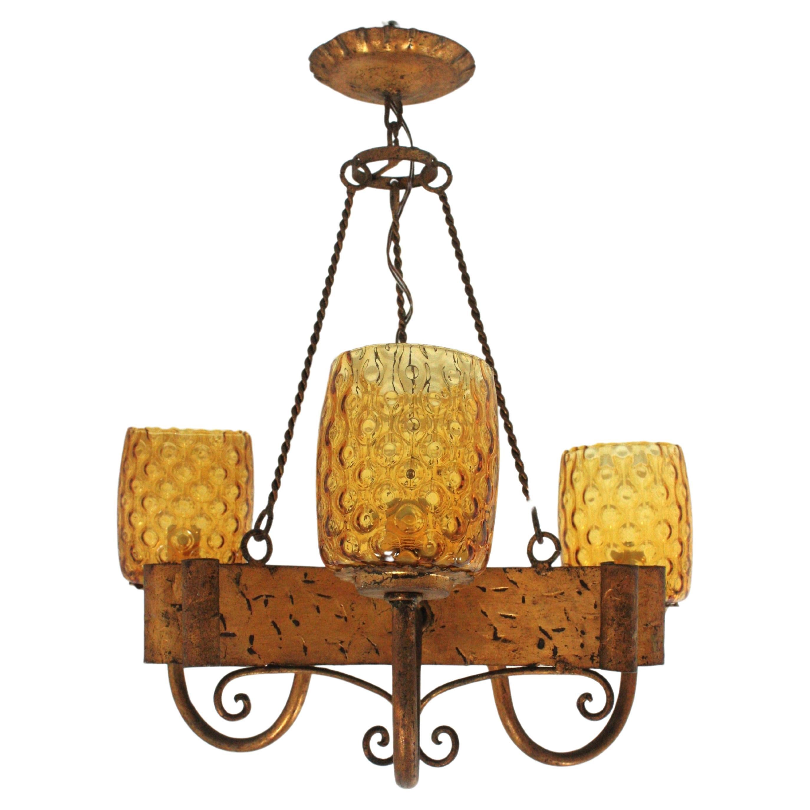 Spanish Gothic Style Chandelier with Amber Glass Shades, Gilt Wrought Iron For Sale
